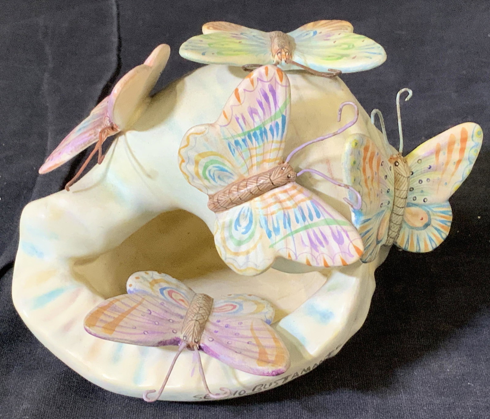 Sergio Bustamante Butterflies on Snail Ceramic Art: Signed Sergio Bustamante Ceramic Snail with 5 Butterflies. A more modern piece from the Mexican Artist. Measures app 6 x 5 x 4 in ht. Possibly c. late 1990s. Signed Sergio Bustamante Ceramic Snail Art