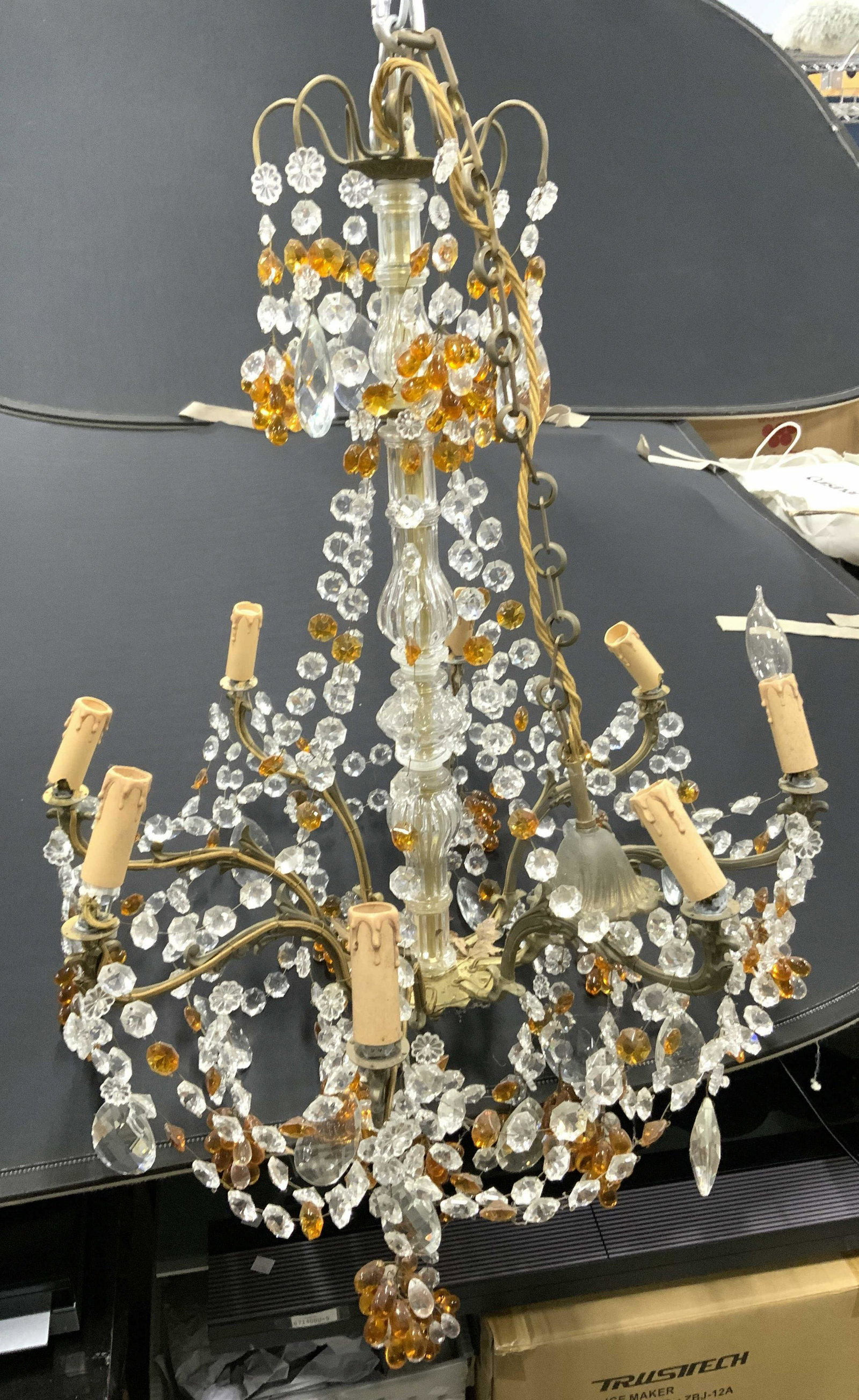 8 Arm Chandelier W Glass Ornaments: 8 Arm Chandelier W Glass Ornaments. grand light fixture with amber and clear prisms, brass toned metal with filigree details. Piece measures approx 65 inches tall 24 inches wide Home lighting, home ac