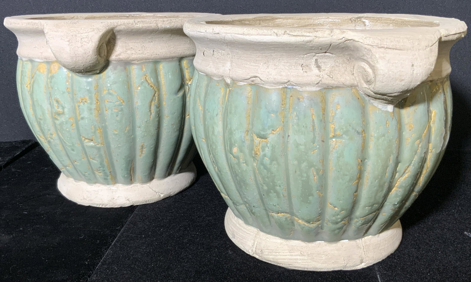 Pr Vntg NORCAL Signed Stoneware Outdoor Planters: A pair of weighty, thick walled stoneware planters. Twin scroll handles on either side. Ribbed and glazed green hued centers. Pieces possess stickers to the underside. Stickers read Norcal. Evident we