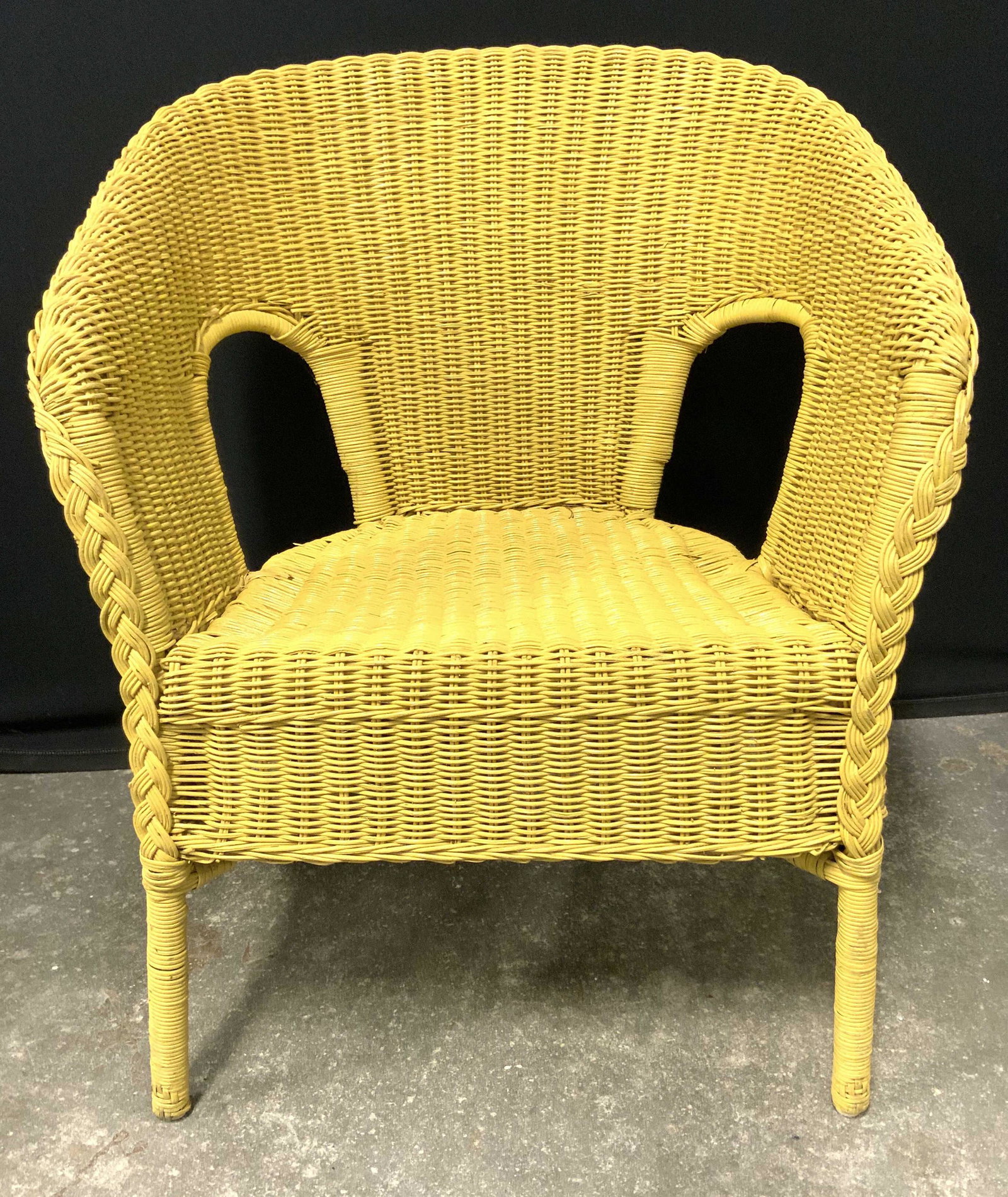 Vintage Yellow Toned Wicker Chair: Chair is yellow toned & vintage. Piece is wicker. Chair has barrel backrest. Piece has 4 legs. Piece measures approx. 31 inches tall 26 inches wide 24 inches deep Chair, barrel back Chair, wicker chai