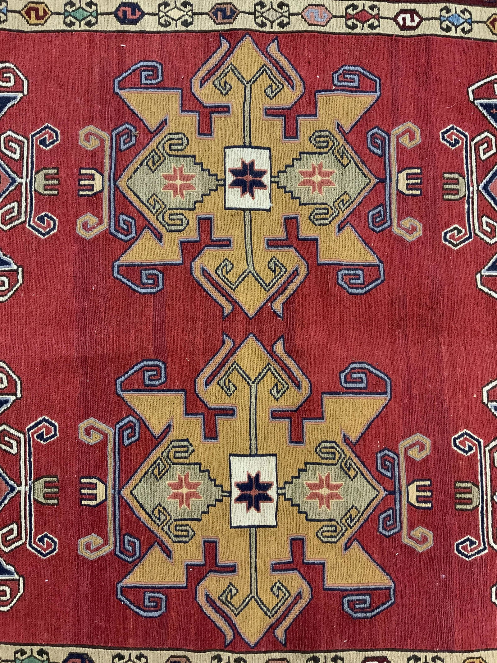 Vintage Fringed Persian Rug: Vintage, possibly antique, fringed Persian rug. One end is fringed. Decorated with multi toned geometric, medallion patterns. Wear is consistent with age and use. Measures approx 59.5 inches long, 39.
