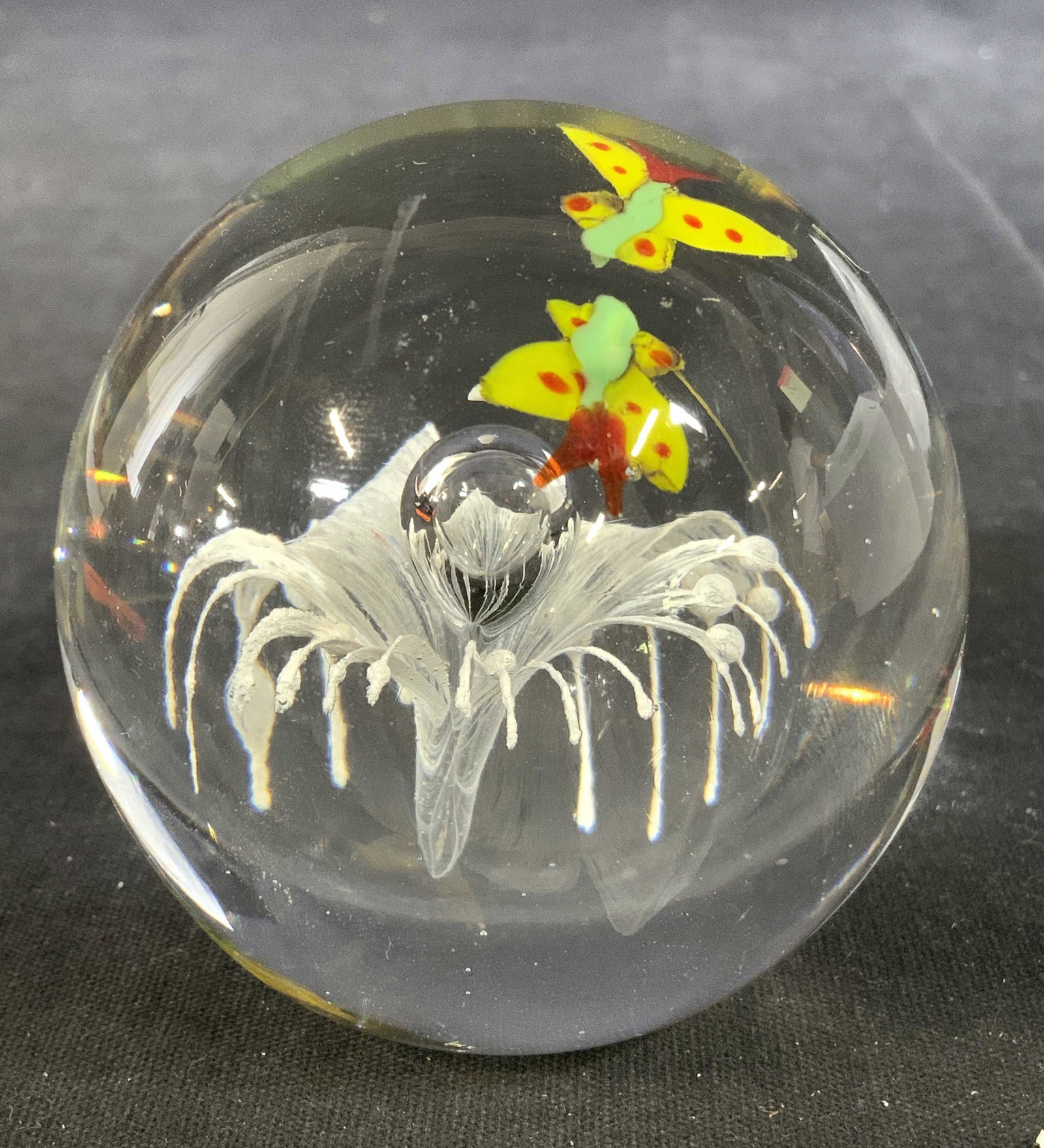 Art Glass Paperweight W Floral & Butterfly Detail: Paperweight is glass. Piece has white toned floral detail with bubble in center & multi toned butterfly detail. 2.5 inches tall & wide. Paperweight, glass paperweight, Art glass paperweight, Art glass