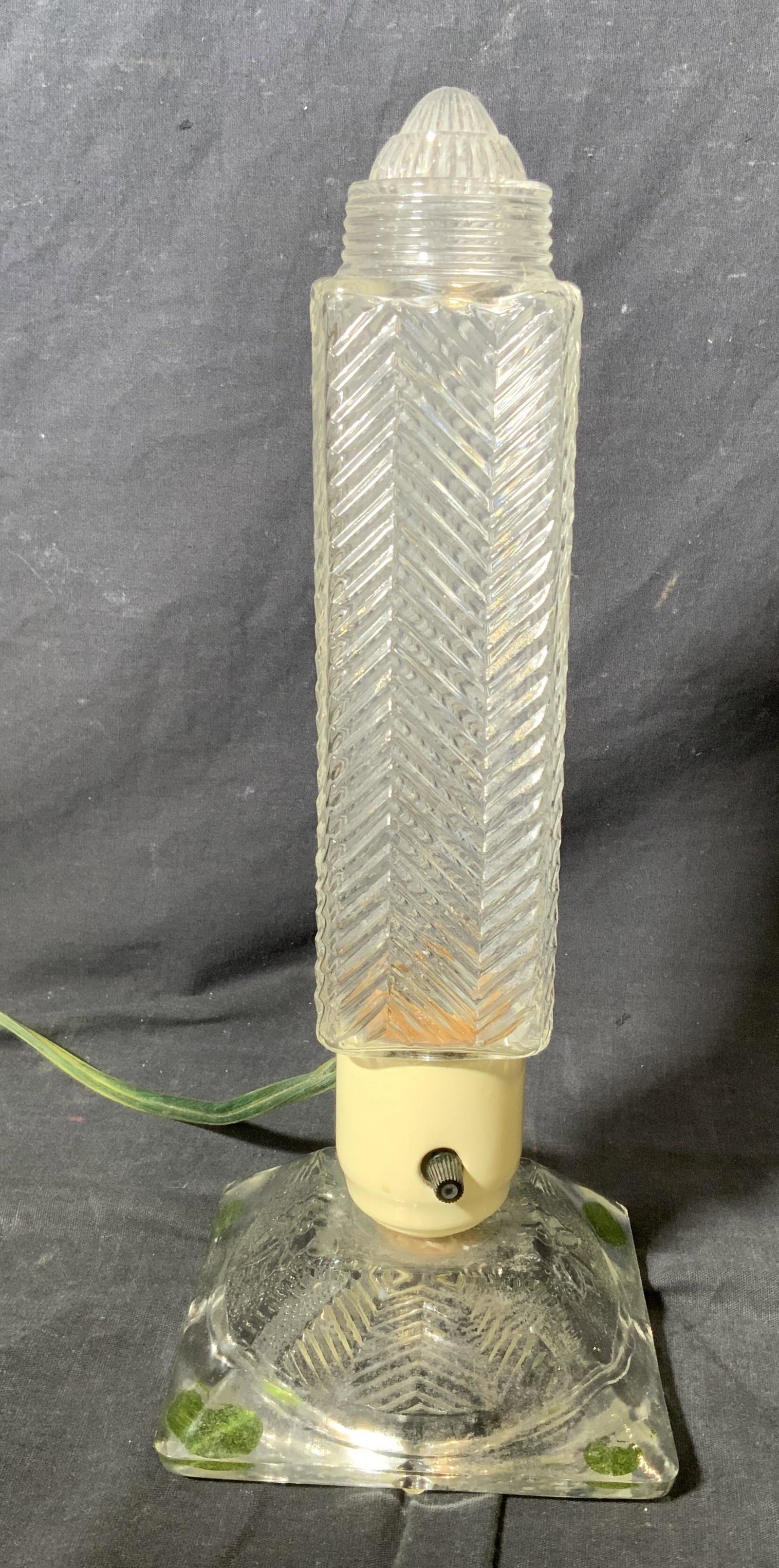 Cylinder Glass Lamp: Cylinder glass lamp, no apparent inscriptions or markings, lamp measures 12 inches at tallest point, glass top to lamp loose to piece, surface wear to overall piece, Cylinder lamp, lamp, lighting, tab
