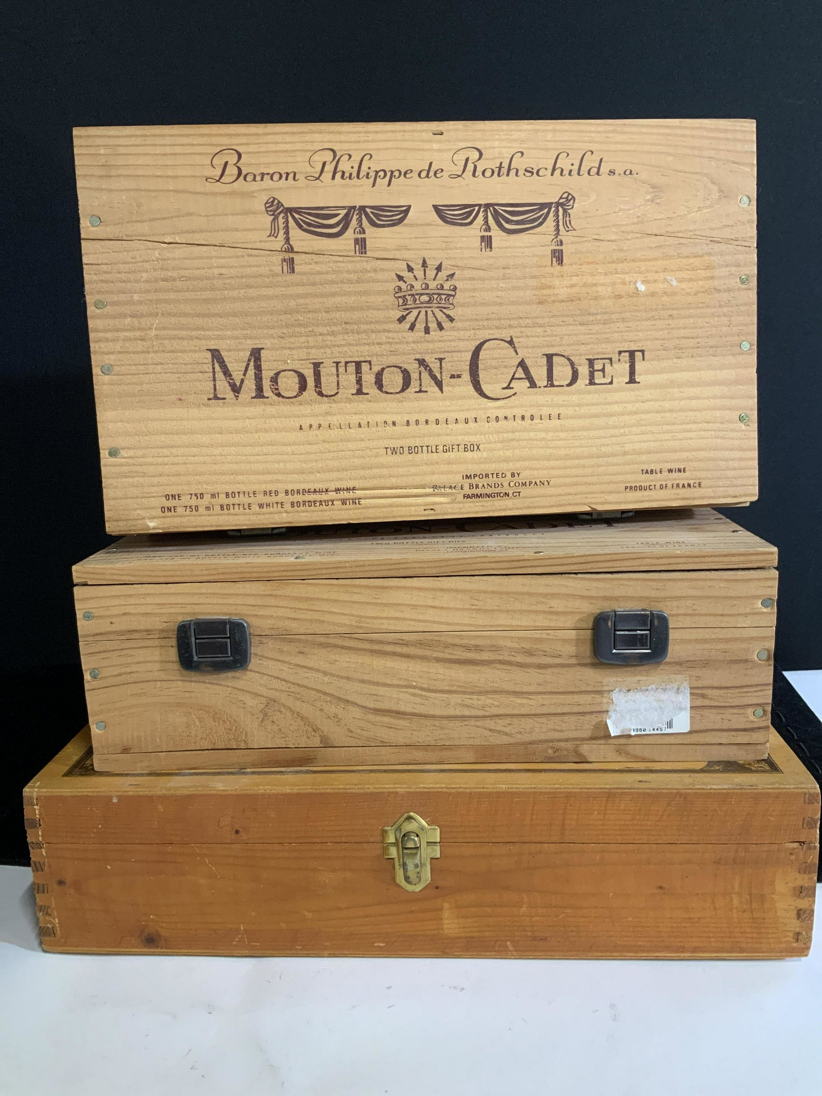 Lot 3 Vintage Wood Wine Boxes, France: Vintage Wine Boxes, hinged lid with secure lock feature. Wood of crate material. 2 boxers are labeled ‘Baron Phillips de Rothschild MOUTON- CADET Product of France’ . Made by hand, 13 x 7 x 4 in. 