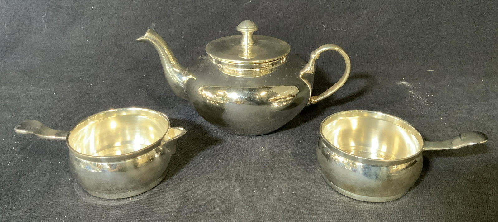 Lot 3 Metal Teapot, Creamer, and Sugar Bowl: Lot 3 Metal Teapot, Creamer, and Sugar Bowl, inscriptions read ‘Made in India’, teapot measures 3 3/4 inches tall x 7 1/4 inches wide, creamer and bow measure 1 1/2 inches tall x 4 3/4 inches, Met