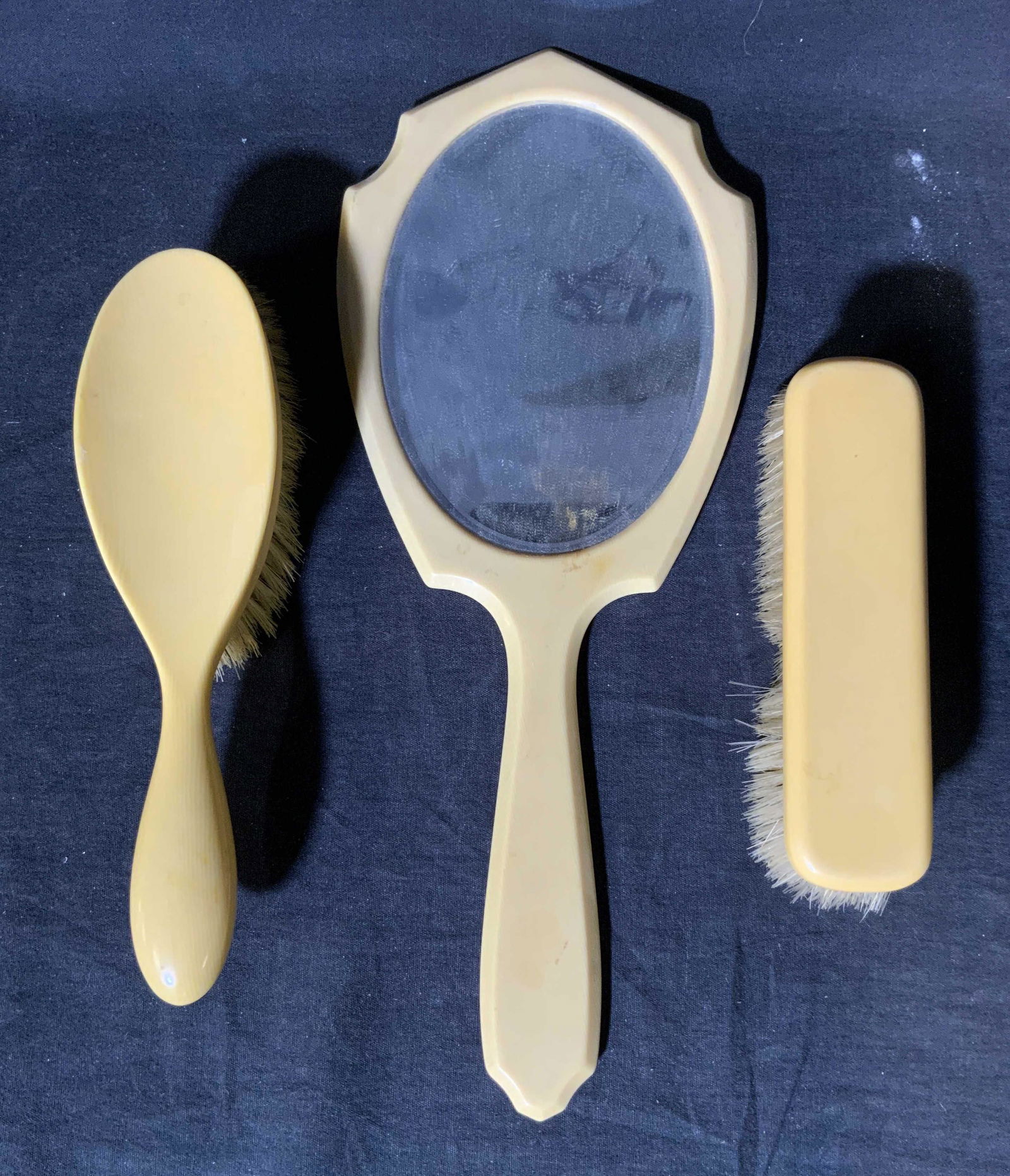 Lot 3 Vintage Celluloid Dresser Accessories: Lot 3 Vintage Celluloid Dresser Accessories, no apparent inscriptions or marks, mirror measures 14 5/8 x 5 7/8 inches wide, smaller brush measures 6 3/4 inches long, wear consistent with use, Vintage,