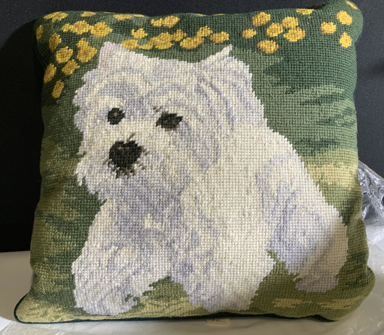 NIP Wool Needlepoint Pillow with Westie Dog: West Highland White Terrier Handmade Needlepoint pillow wrapped in cellophane. Rich Hunter green plush backside with zipper. Wool Needlepoint depicts a Westie Dog trotting in the grass near yellow flo