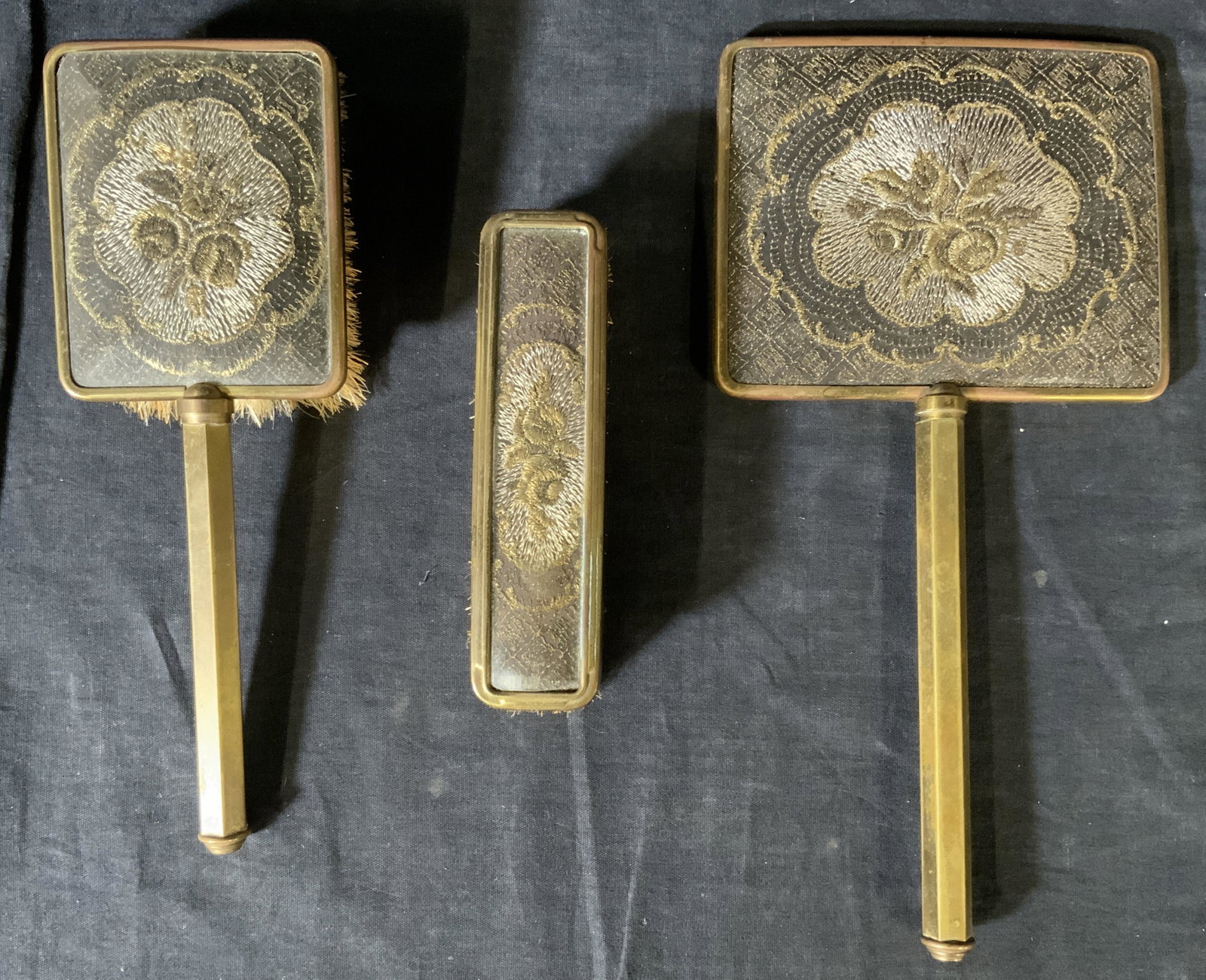 Set 3 Antique Dresser Brushes & Mirror: Set 3 Antique Dresser Brushes & Mirror, inscriptions read ‘Made in England’, smallest brush measures 5 5/8 inches at widest point, 1 1/2 inches tall, mirror measures 11 x 5 1/2 inches, surface wea