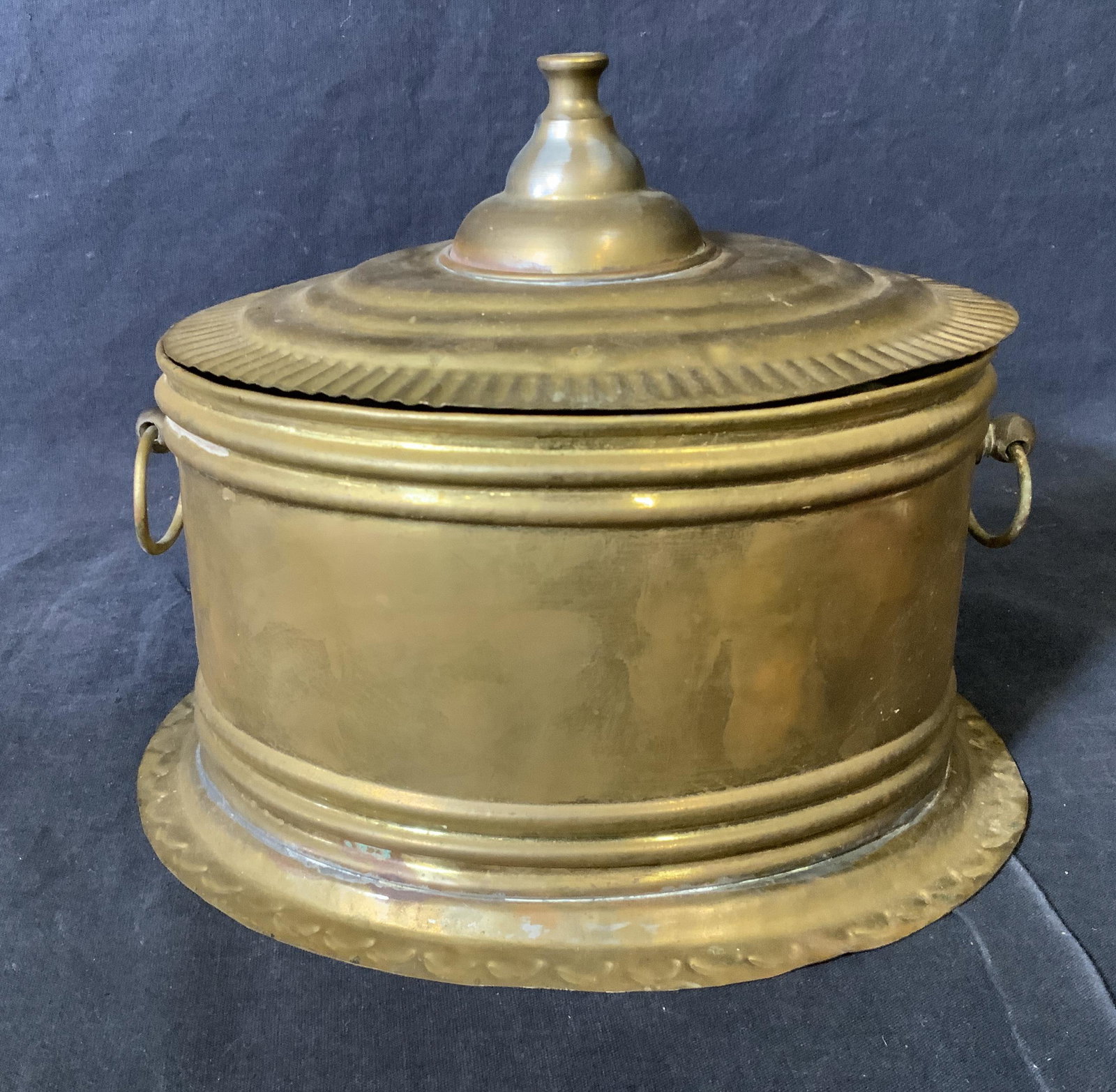 Antique Brass Biscuit Tin: Antique brass biscuit tin, no apparent inscriptions or markings, made of stamped brass, oxidation throughout, surface wear to piece, measures 7 inches tall and approximately 8.5 inches wide wide, hand