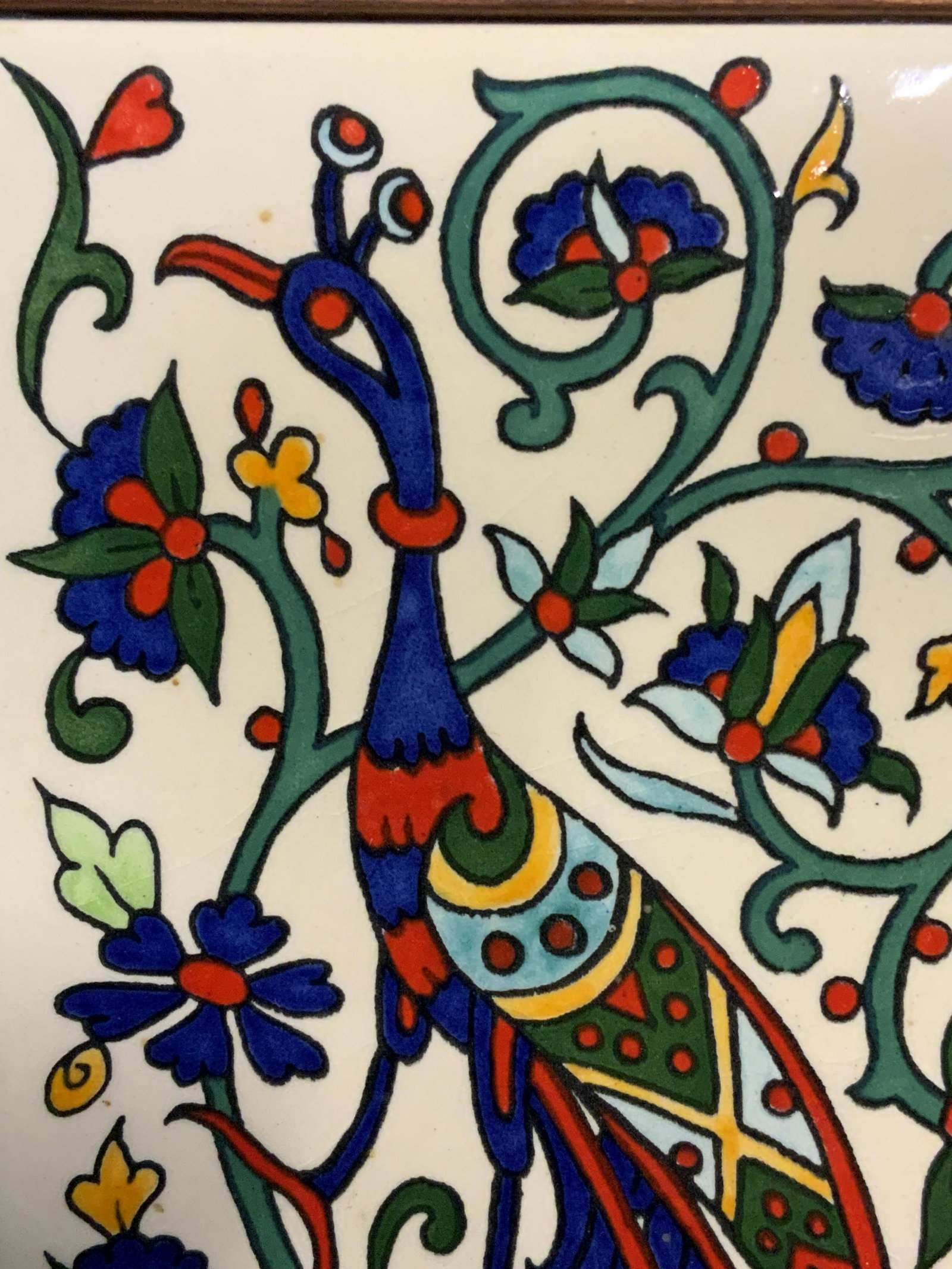 Framed Bird on Ceramic Tile: Framed Bird on Ceramic Tile, verso reads ‘ Jerusalem Pottery Karakashian Bros.’, subject a profile view of a peacock in bright colors surrounded by scroll patterning, measures 5 1/8 x 9 1/4 inches