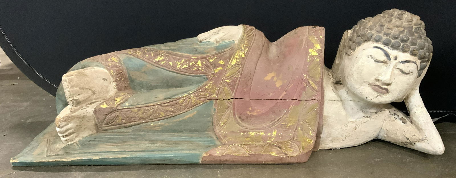 Vintage Carved Wooden Laying Buddha Sculpture: Buddha sculpture is vintage possibly antique. Piece is wooden & appears to possibly be hand carved. Sculpture depicts Buddha laying on side. Piece appears to hand painted, & gold gilt detail. Piece me