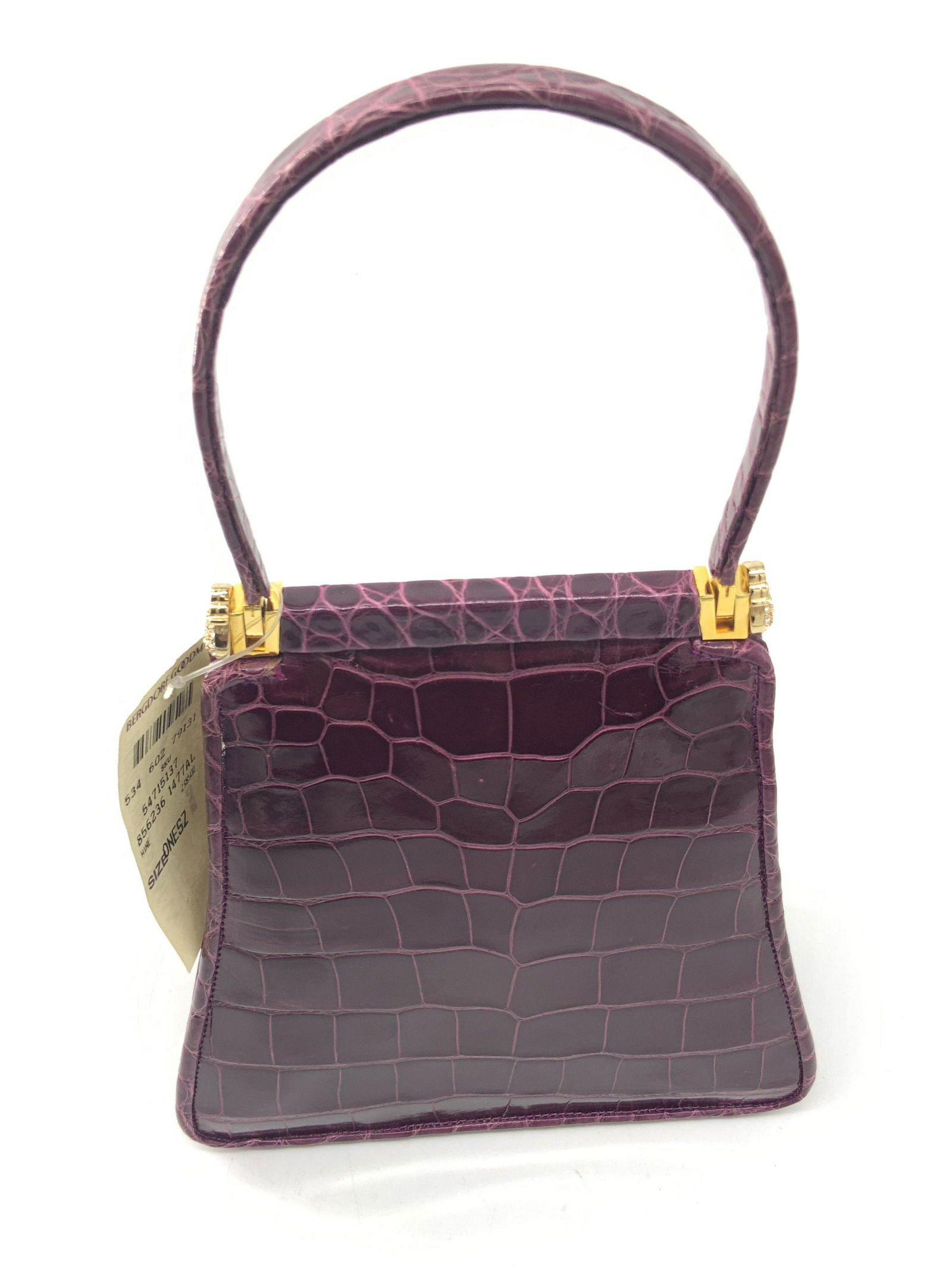 Vntg JUDITH LEIBER Croc Mini Purse, Tag & Dust Bag: A vintage mini purse with a bejeweled accents on either side of top handle. Deep wine hue. Crocodile style. Gold tone metal hardware. Snap closure. Lined interior. Interior signed JUDITH LEIBER. Inter