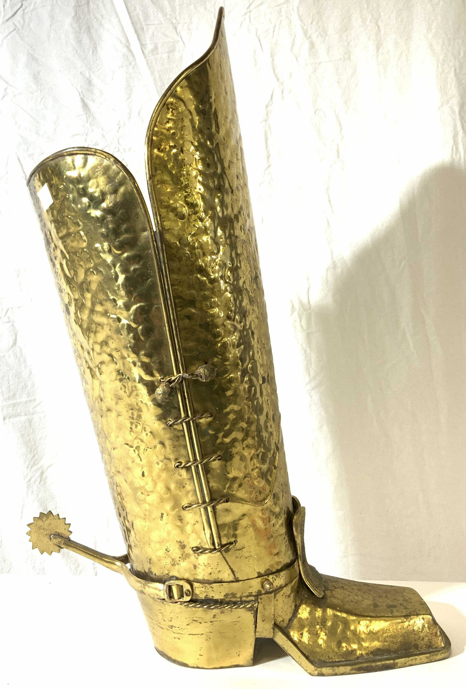 Vintage Gold Toned Metal Boot Sculpture: Boot sculpture is vintage. Piece is gold toned & metal, possibly brass. Sculpture has spur on backside. Piece measures approx 24 inches tall 16 inches deep 5.5 inches wide. Sculpture, boot sculpture, 