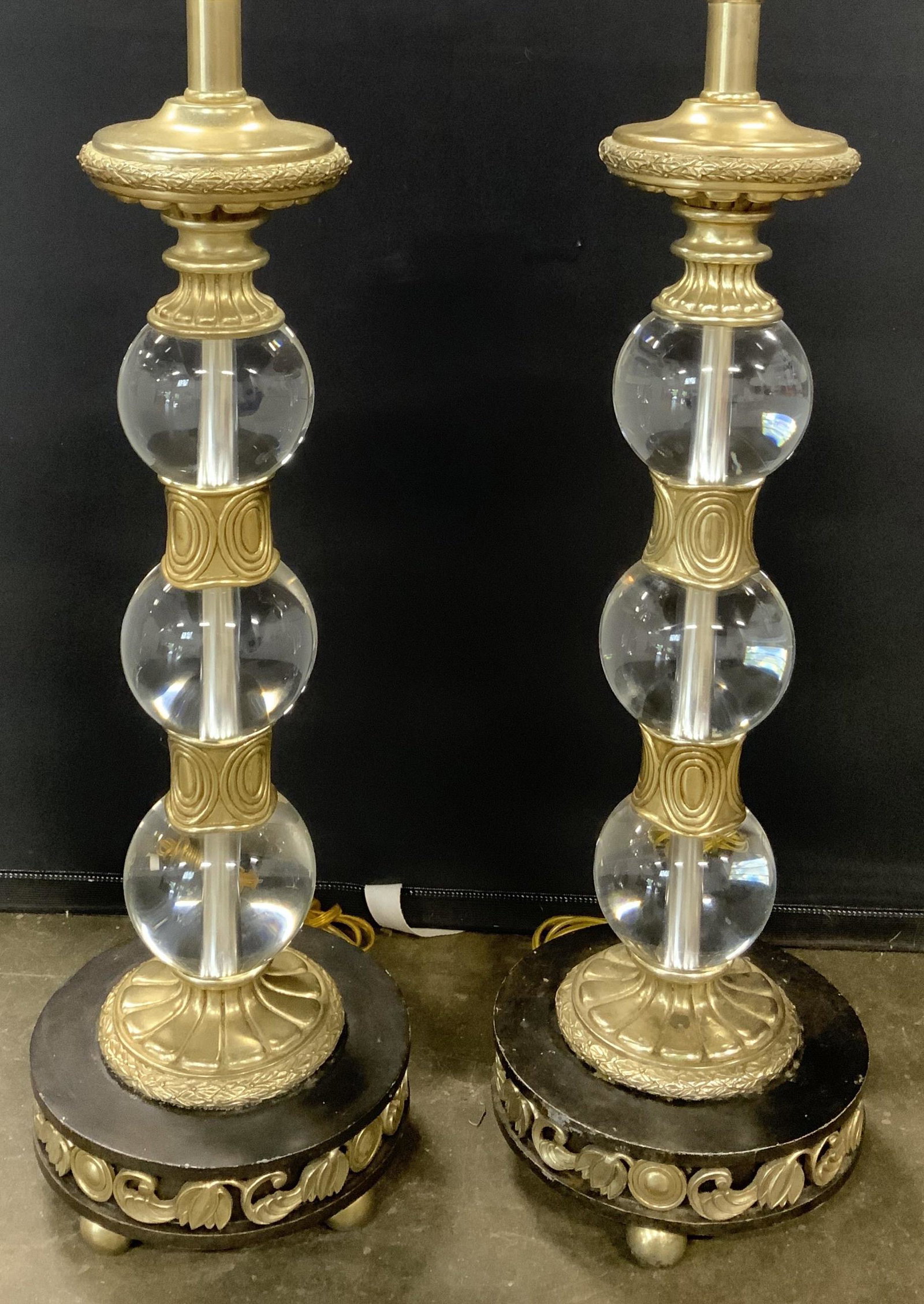 Pair MAITLAND SMITH Glass & Metal Lamps: Lot includes 2 lamps. Each have tags which read MAITLAND SMITH. Each lamp has spherical shaped feet. Lamps each have 3 glass spherical structures. Each lamp has gold toned detail with relief which app