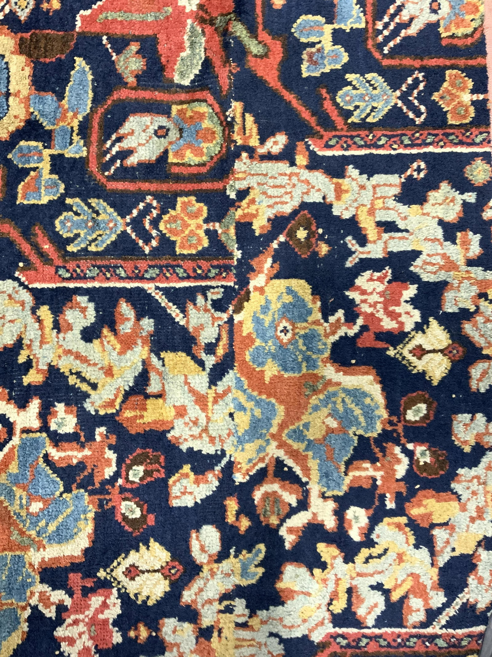 Vintage Handmade Wool Area Rug: Rug is handmade and wool. Piece is vintage possibly antique. Rug contains intricate multi toned floral, vine & geometric detail. Piece measures approx 40 inches tall 23 inches wide. Rug, carpet, wool 