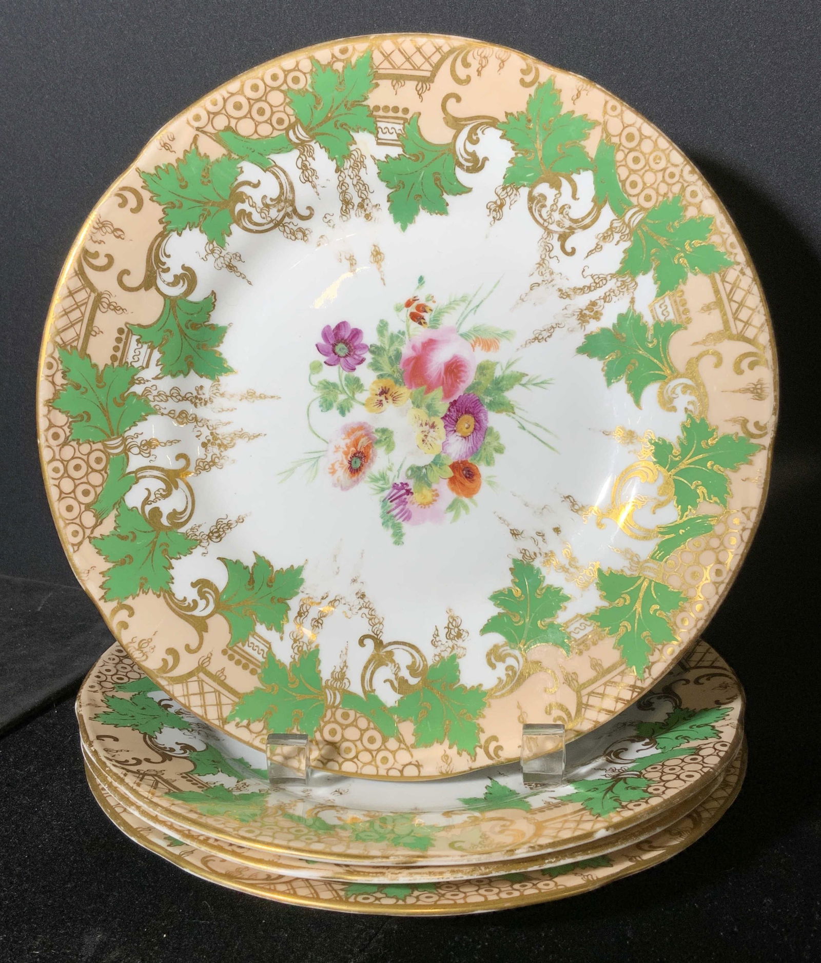 Lot 4 Hand Painted ROCKINGHAM Style Plates: Lot 4 ROCKINGHAM style porcelain plates. Plates are hand painted, floral patterns decorate the well of each plate, lips and rims are detailed with gilt paint, and green leaves. Wear is consistent with