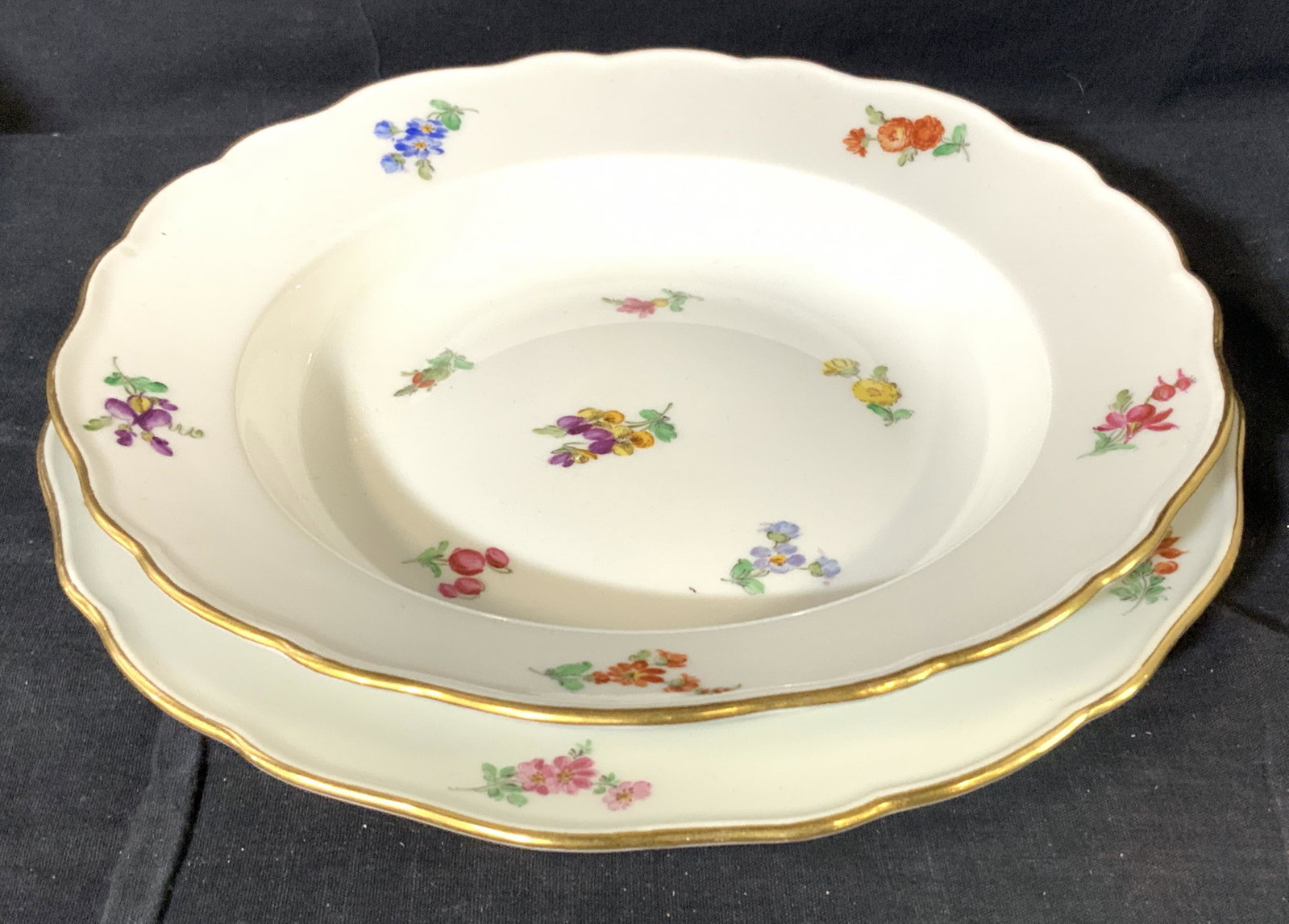 MEISSEN Floral Plate and Bowl, Hallmarked: Hallmarked Meissen white porcelain bowl with matching dinner plate. Hand painted flowers with gilt rim. Verso has blue sword Hallmark under glaze, plate has additional 123. Plate 9.75 in. Luxury porce