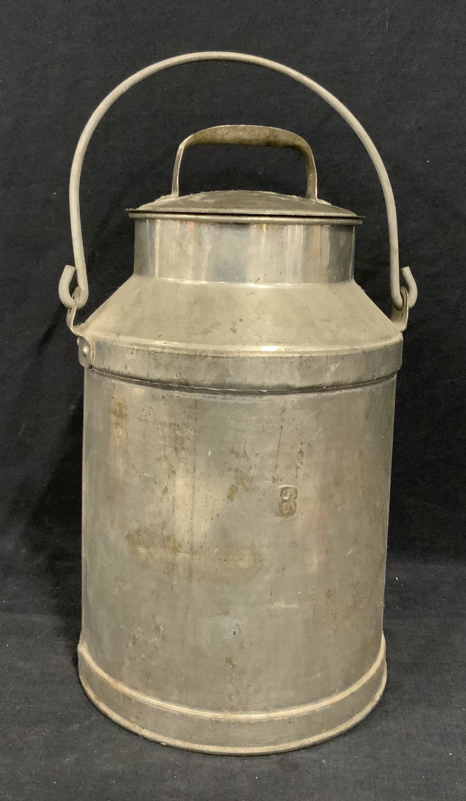Antique Aluminum 8 Gallon Milking Can: Antique Aluminum Milking Can, no apparent inscriptions, jug has a Base diameter of 8 1/2 inches, lip has a diameter of 6 inches, jug has a height of 14 3/8 inches without handles, handles bring height