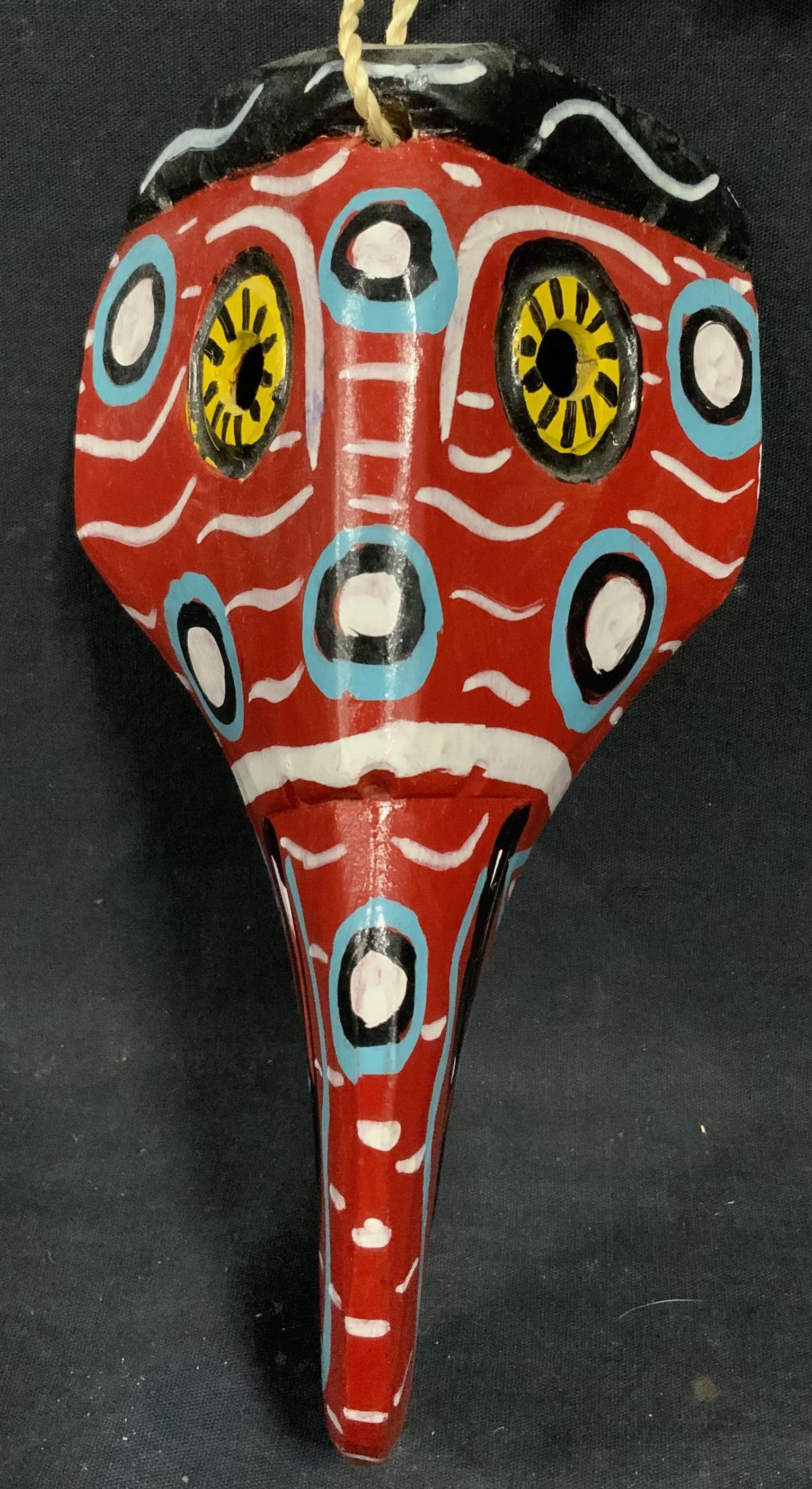 Abstract Bird African Style Wood Mask: Abstract Bird African Style Wood Mask, shows an an abstracted bird painted brightly with red, yellow, and blue hues, could possibly be an elephant, measures 4 1/2 x 8 3/4 inches, wear consistent with 