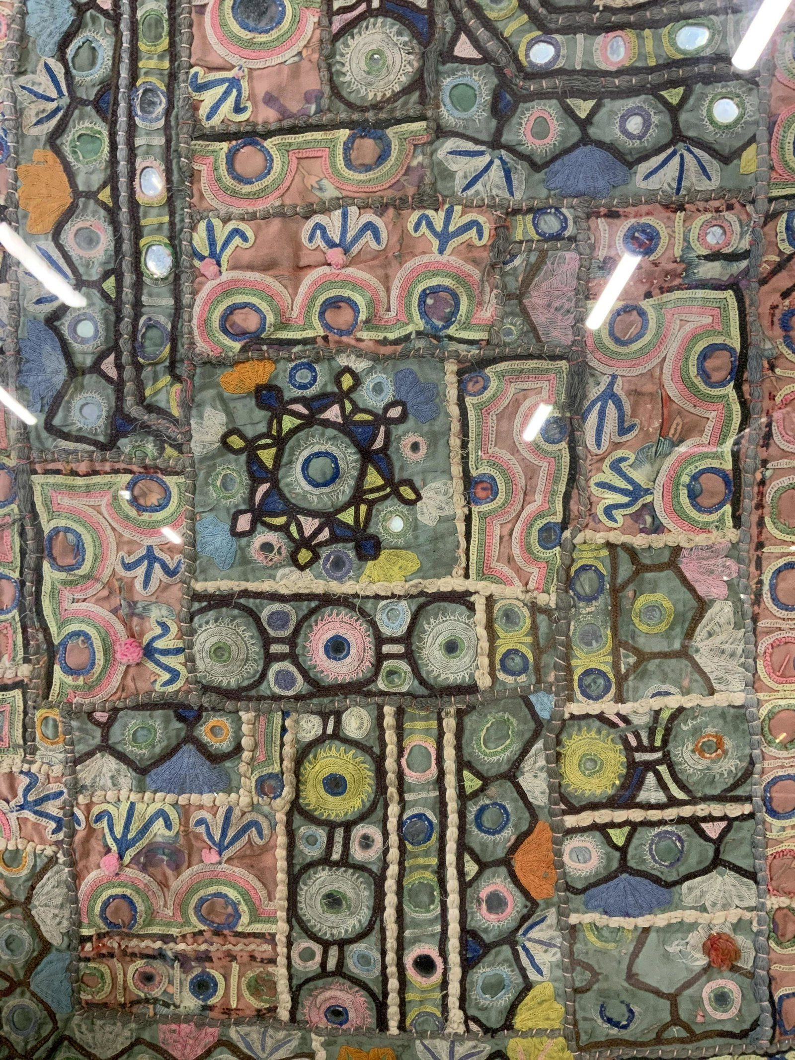 Vintage Embroidered Mixed Media Artwork: Vintage Embroidered Artwork Possibly antique, no apparent inscriptions to piece, subject various materials embroidered sewn together with circular mirrors throughout the piece, measures 17 1/8 x 30 in