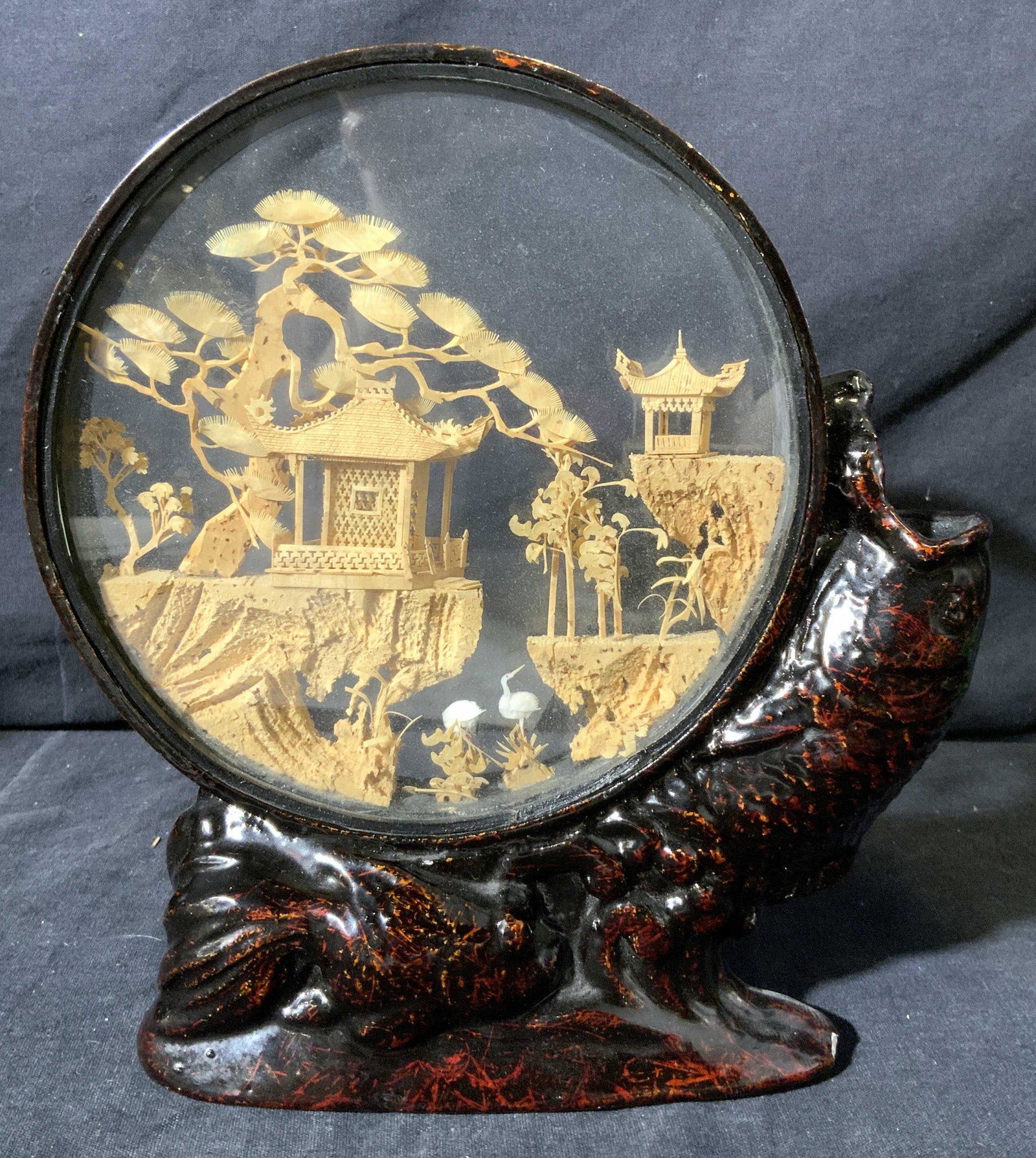 Eastern Asian Cork Sculpture Encased in Glass: Eastern Asian Cork Sculpture Encased in Glass, hallmark to upper edge in Asian characters,, subject a depiction of Asian pavilions on a cliff side with trees and cranes encased in class with a metalli