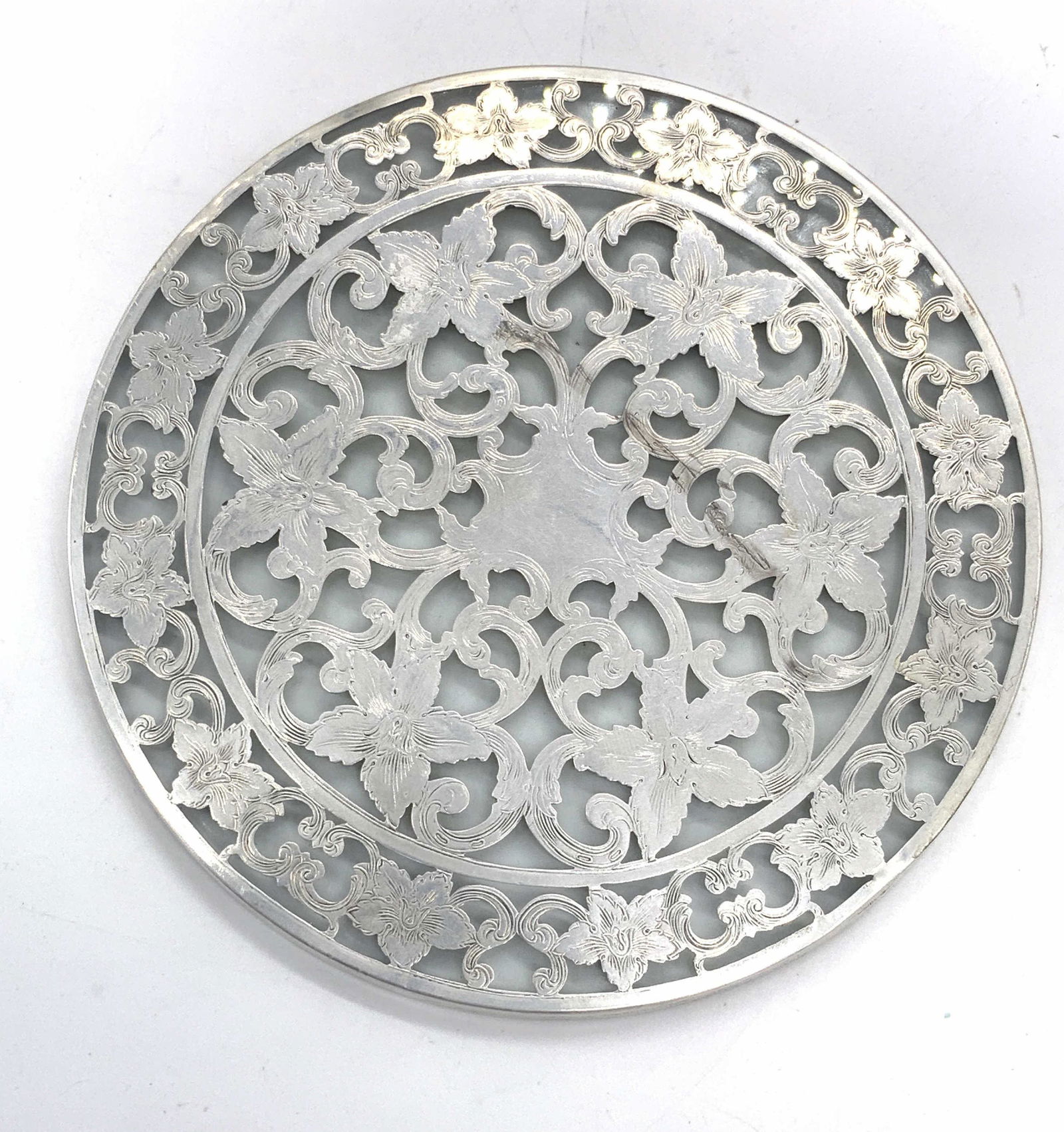 Vntg STERLING SILVER & Glass Signed Floral Trivet: A vintage sterling silver and glass trivet. Signed Sterling on the side. Measures approx 6 x 6 inch diameter. Total weight 9.50 ozt. Surface wear consistent with age and use. Sterling silver trivet, s
