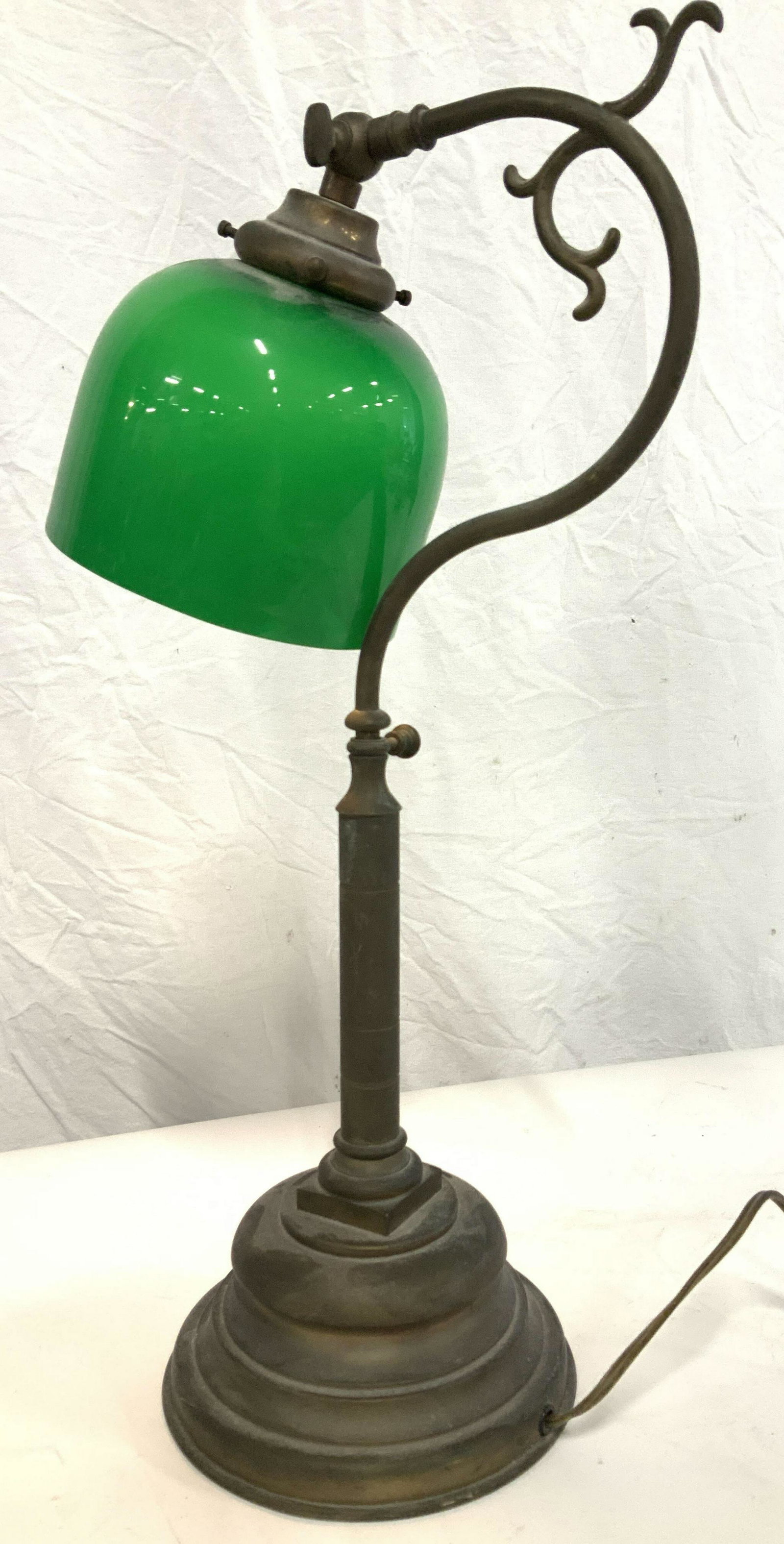 Arts & Crafts Banker’s Lamp w/ Green Glass Shade: Sophisticated metal lamp with green glass shade. Vintage and Styled in the Arts and Crafts era. Needs brighter watt bulb if designer. Long cord, measures 21 in. Ht, 11 in. Depth. Arts and Crafts Lamp,