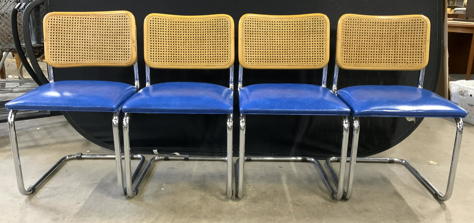 Set 4 MCM METCO INDUSTRIES Cantilever Chairs: Undersides of chairs have tags which read METCO INDUSTRIES. Each chair is a Marcel Breuer cantilever chair. Chair frames appear to be chrome. Each chair has blue toned leather upholstered seat cushion
