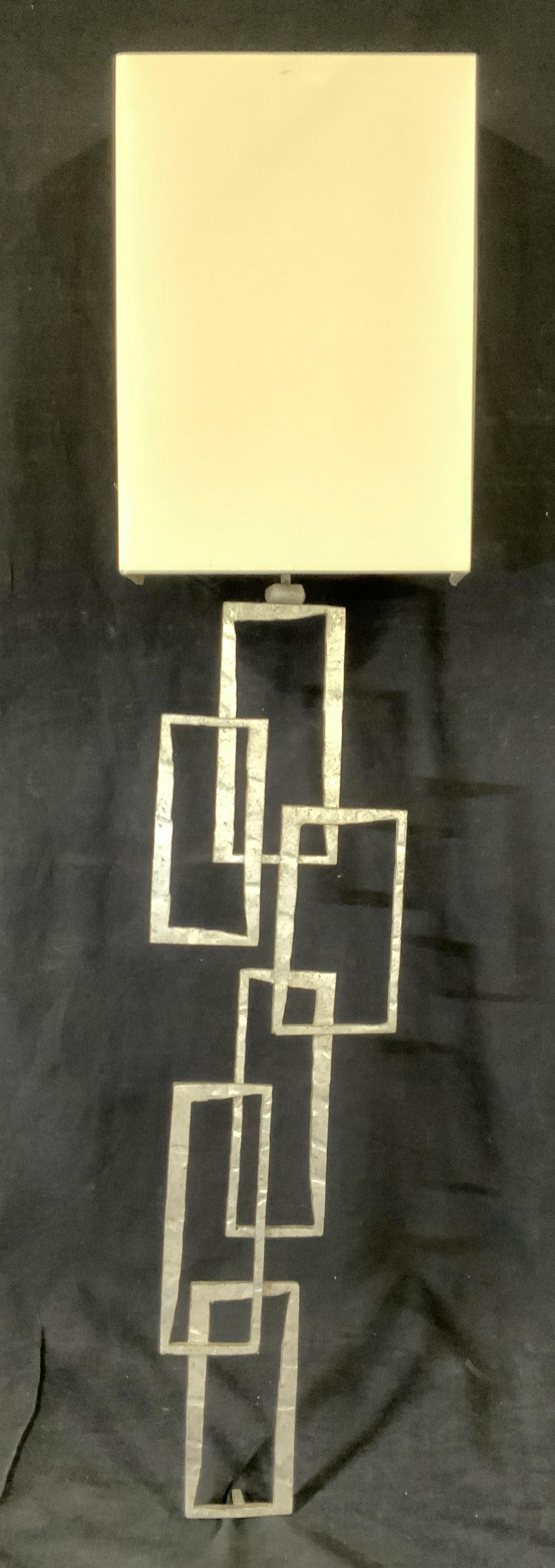 ROMANA Silver Toned Modern Brutalist Light Sconce: Rug is wool pile and handmade. Piece has short cream toned fringes. Rug contains multi toned floral motif detail in addition to geometric detail. Piece measures approx 107 inches long 69 inches wide. 