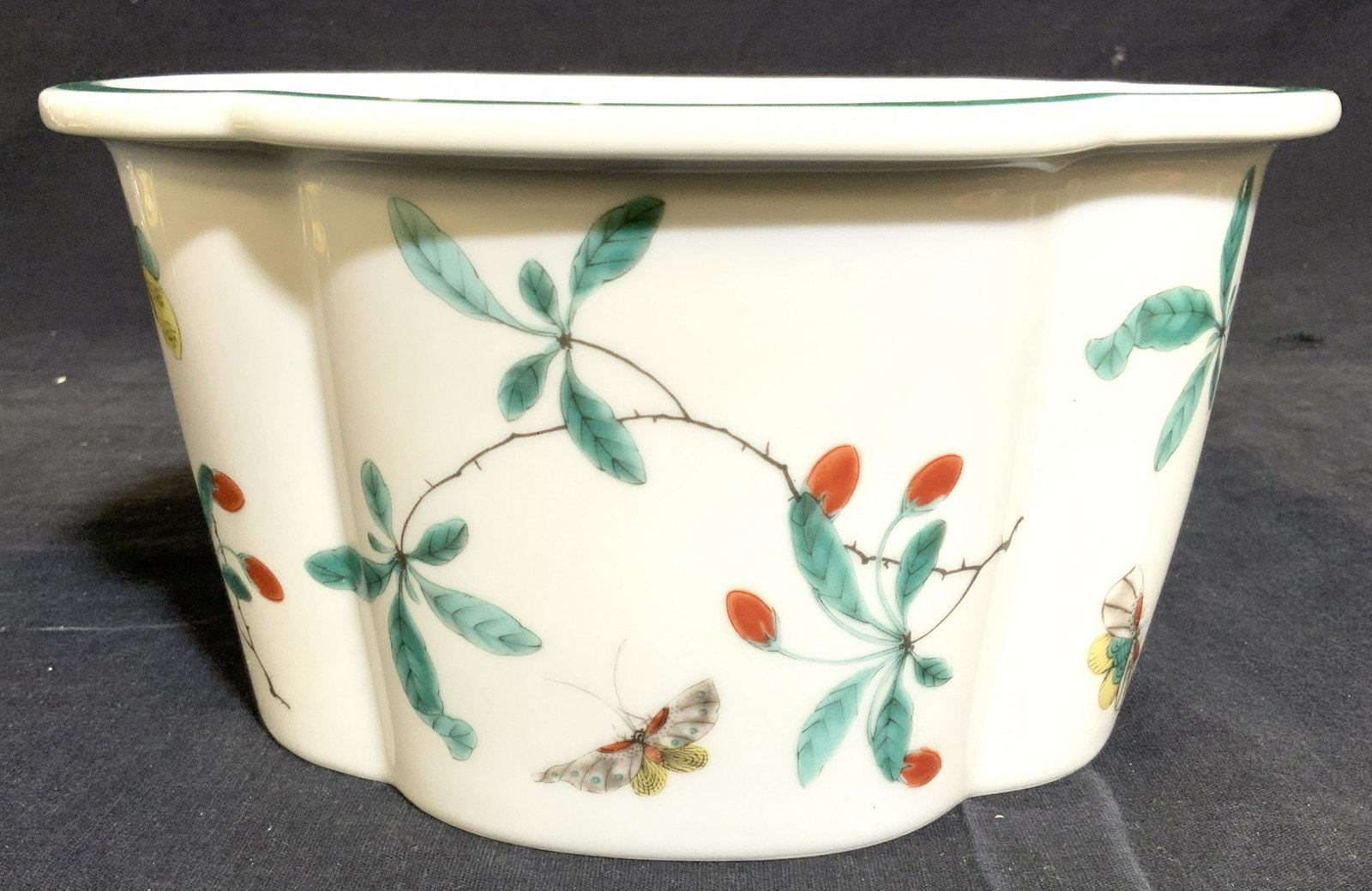 MOTTAHEDEH Porcelain Planter W Vine & Leaf Detail: Underside of piece is marked MOTTAHEDEH. Piece is porcelain. Planter has multi toned floral, leaf, vine and butterfly detail. Piece measures approx 8.5 inches long 6.5 inches wide 4.5 inches tall. MOT