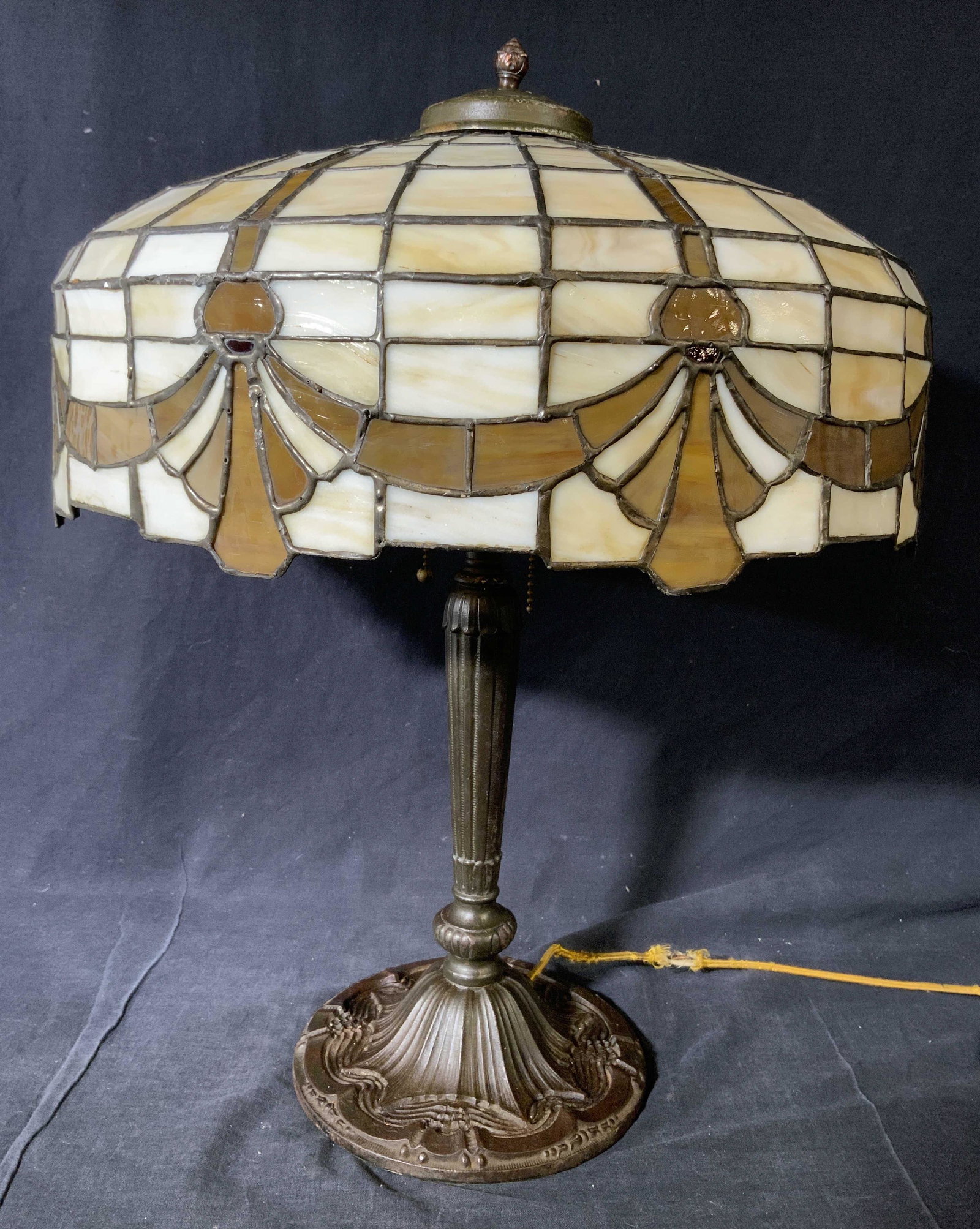 Antique Pittsburgh Leaded Slag Glass Lamp C 1910: Lamp is antique circa 1910. Piece has stained glass, slag glass shade with cream and amber tones. Lamp includes finial. Piece has 2 bulb sockets with dangling pull switches. Lamp is significantly weig