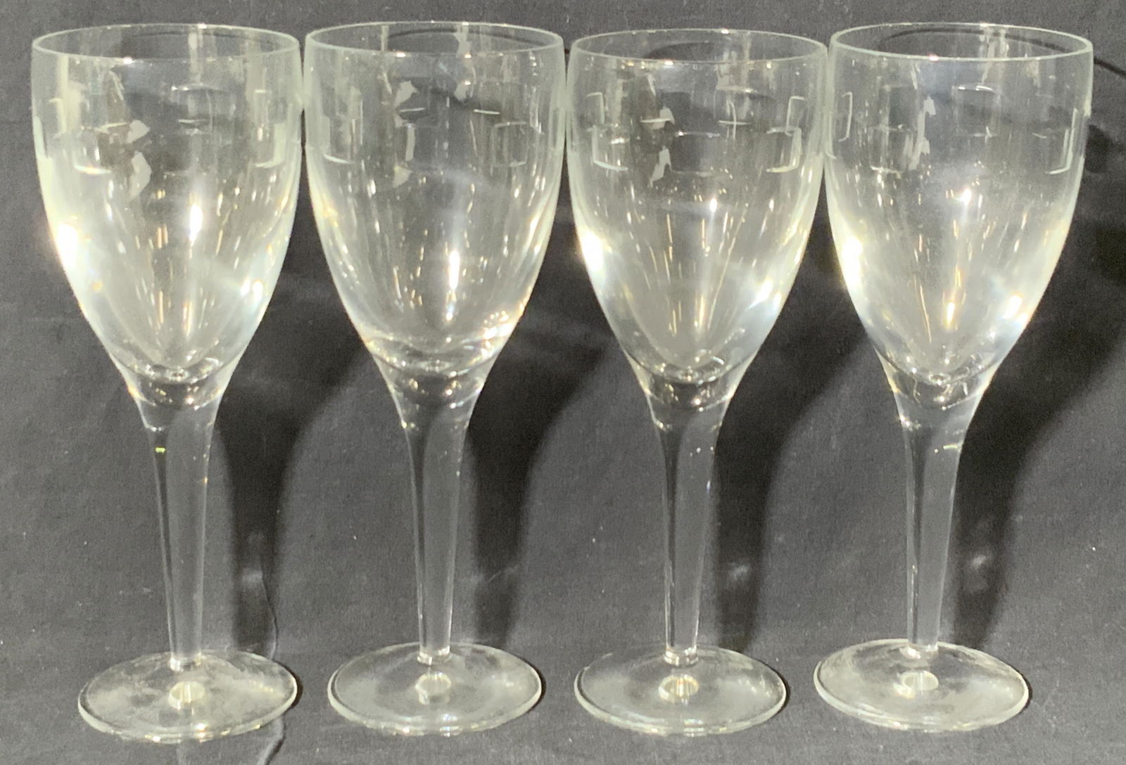 Set 4 Vntg JOHN ROCHA Waterford Crystal Stemware: Four thick walled crystal wine glasses contained in their original packaging. Signed on the underside John Rocha Waterford. Exterior reads John Rocha Waterford. Stemware measures approx 9H x 3W in. Bo
