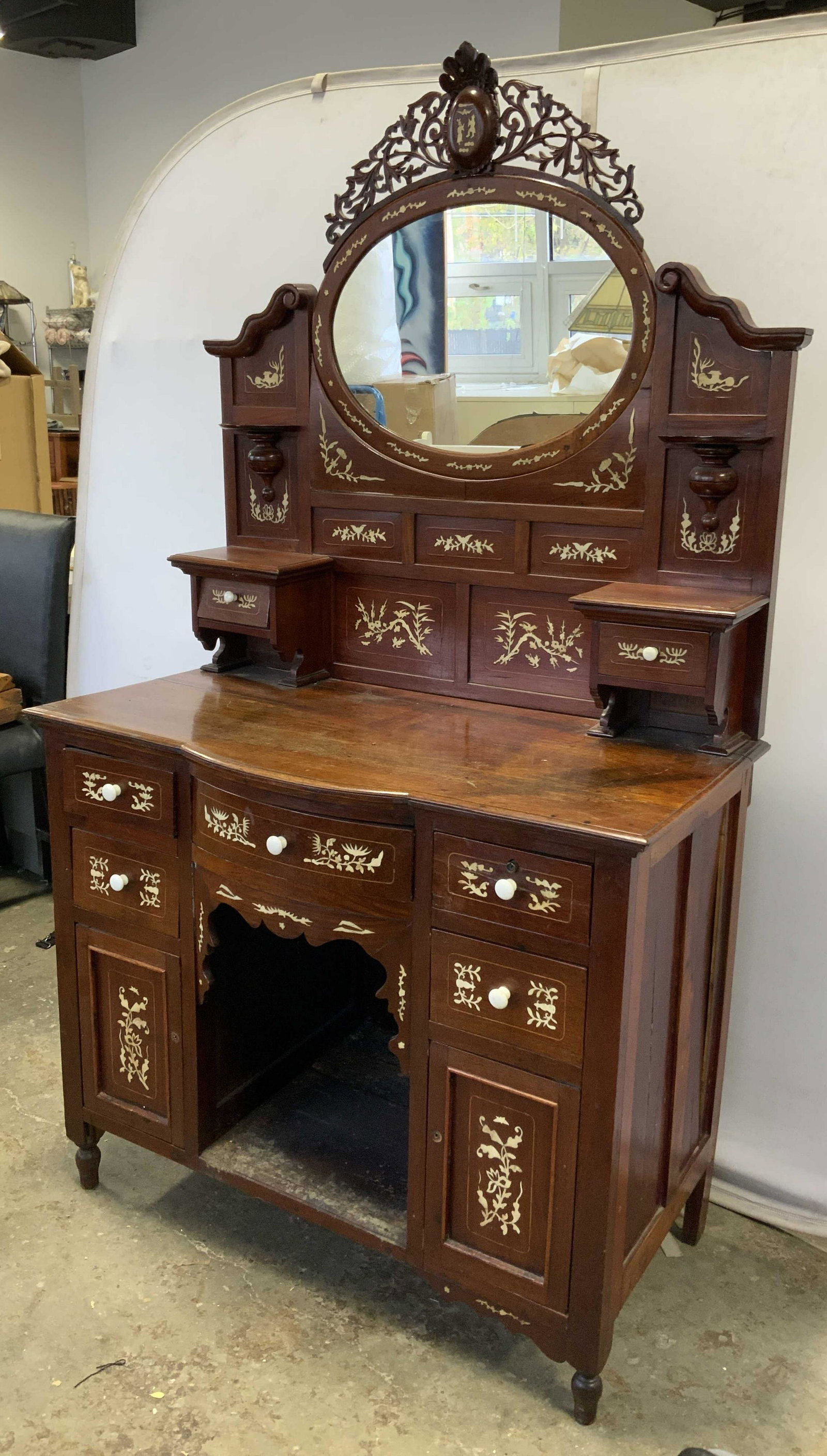 Antique Chinoiserie Vanity w Decorative Bone Inlay: Antique wooden vanity. Decorated with carved bone inlay. Inlaid detailing resembles plants, and birds. Mirror flanked by detailing resembling dogs, apex of mirror depicts two figures and a bird a,one 