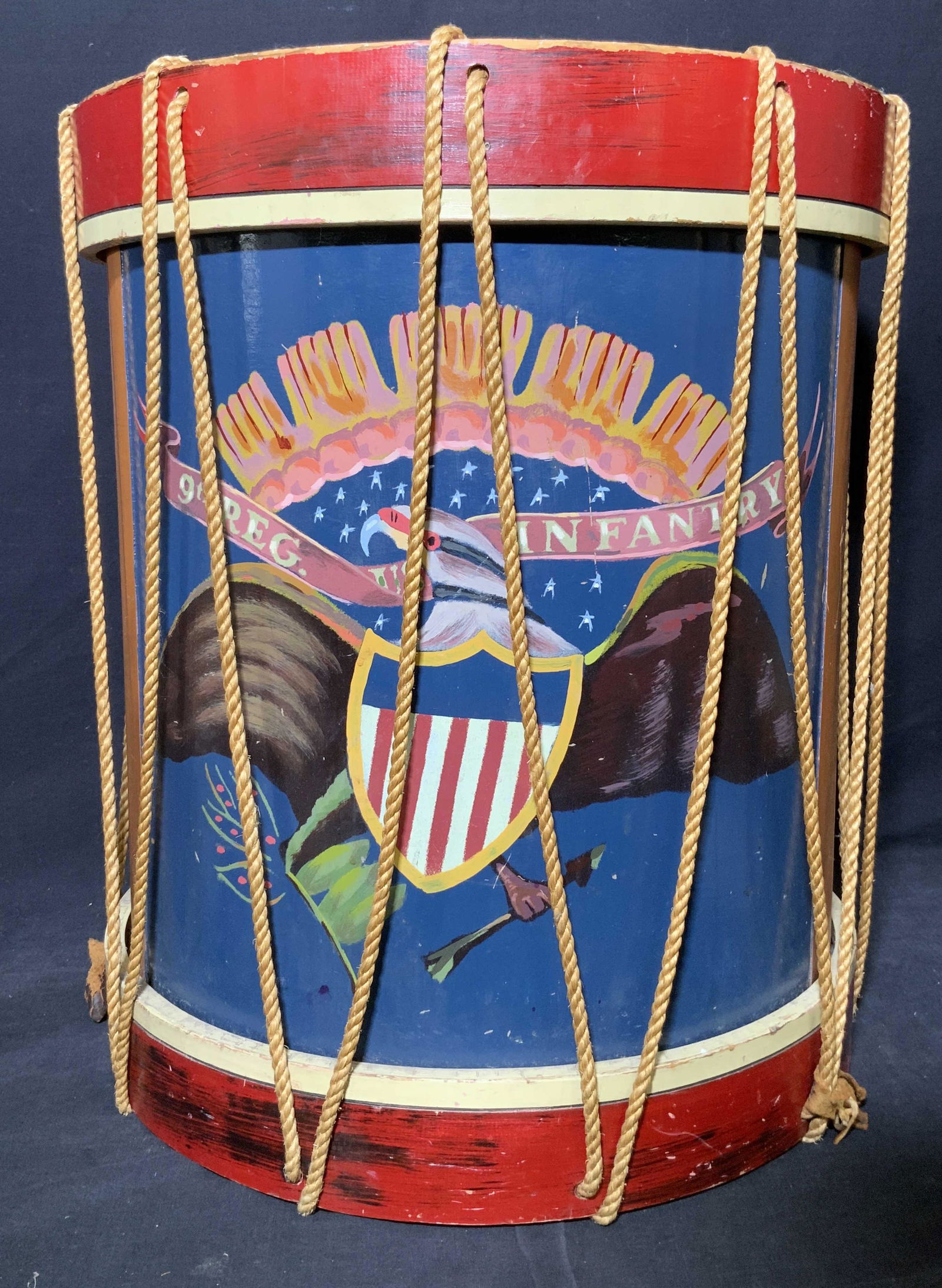 Antique 9th Reg. Infantry Drum: Antique 9th Reg. Infantry Drum, drum body reads ‘ 9th Reg. Infantry, subject a drum with a wooden body and ropes to the sides of body, measures 22 x 18 1/2 x 18 1/2 inches, surface wear and chips to