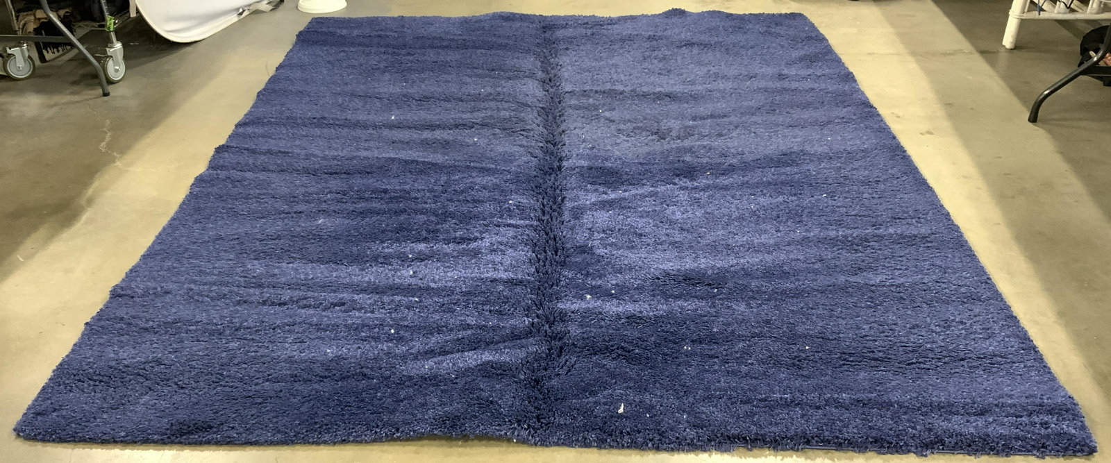 SAFAVIEH Navy Toned Shag Rug: Underside of piece has tag which reads SAFAVIEH. Piece is shag and navy toned. Piece measures approx 121 inches long 98 inches wide. Rug, carpet, area rug, shag rug, SAFAVIEH rug. Piece needs deep cle