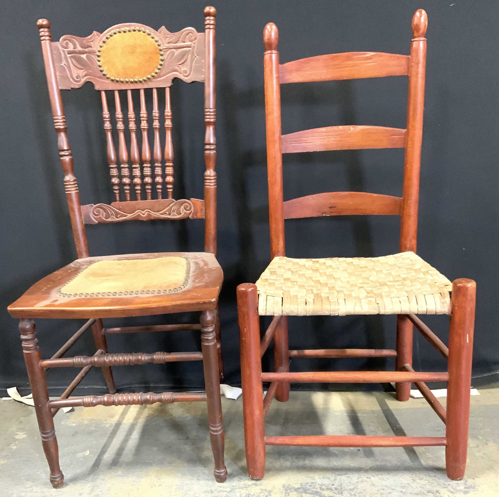 Lot 2 Vintage Wooden Chairs: Lot includes 2 chairs. Each are vintage possibly antique. Chairs each have carved wooden structures. 1 chair has ladder back, while the other has intricately carved detail. Each chair has box stretche