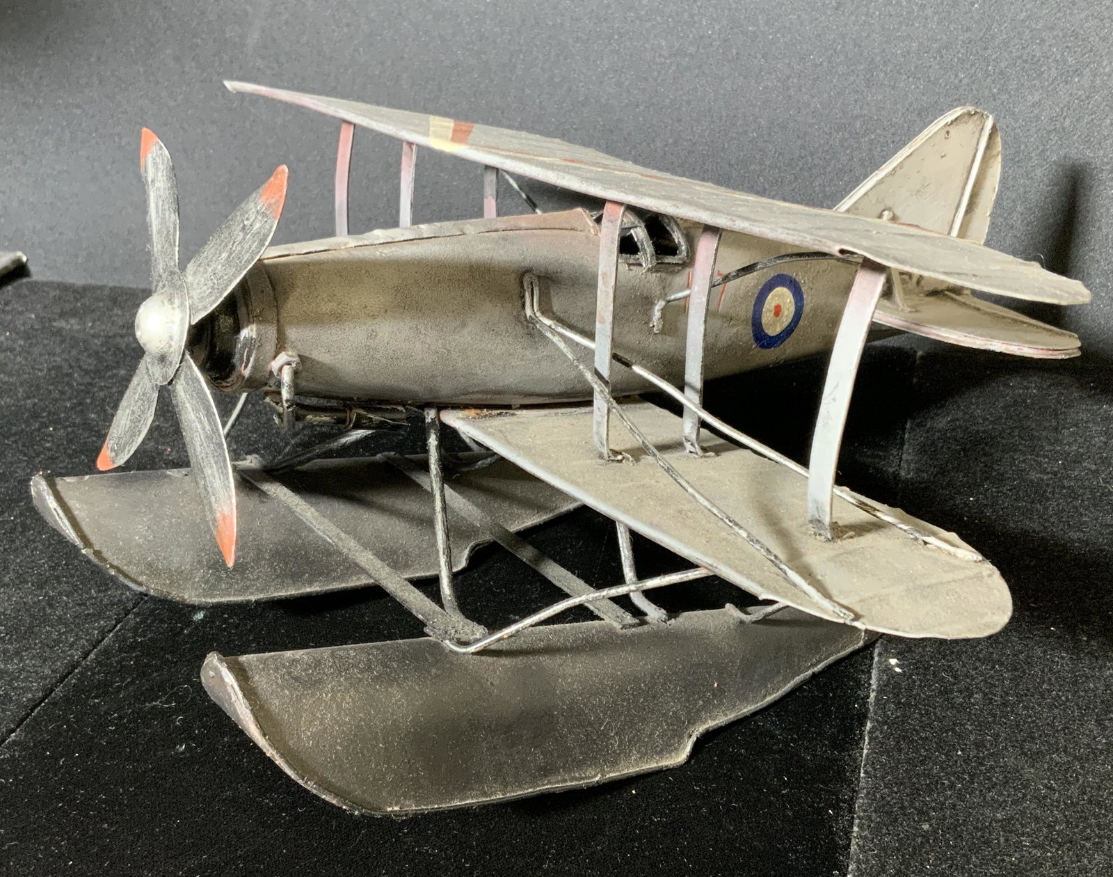 Vintage Metal Sea Plane Figural: Vintage metal sea plane. Hand painted patterns decorate wings, side of plane reads as K27, underside is marked 361. Measures approx 5.75 inches h, and 11 inches long. Wear is consistent with age. Vint