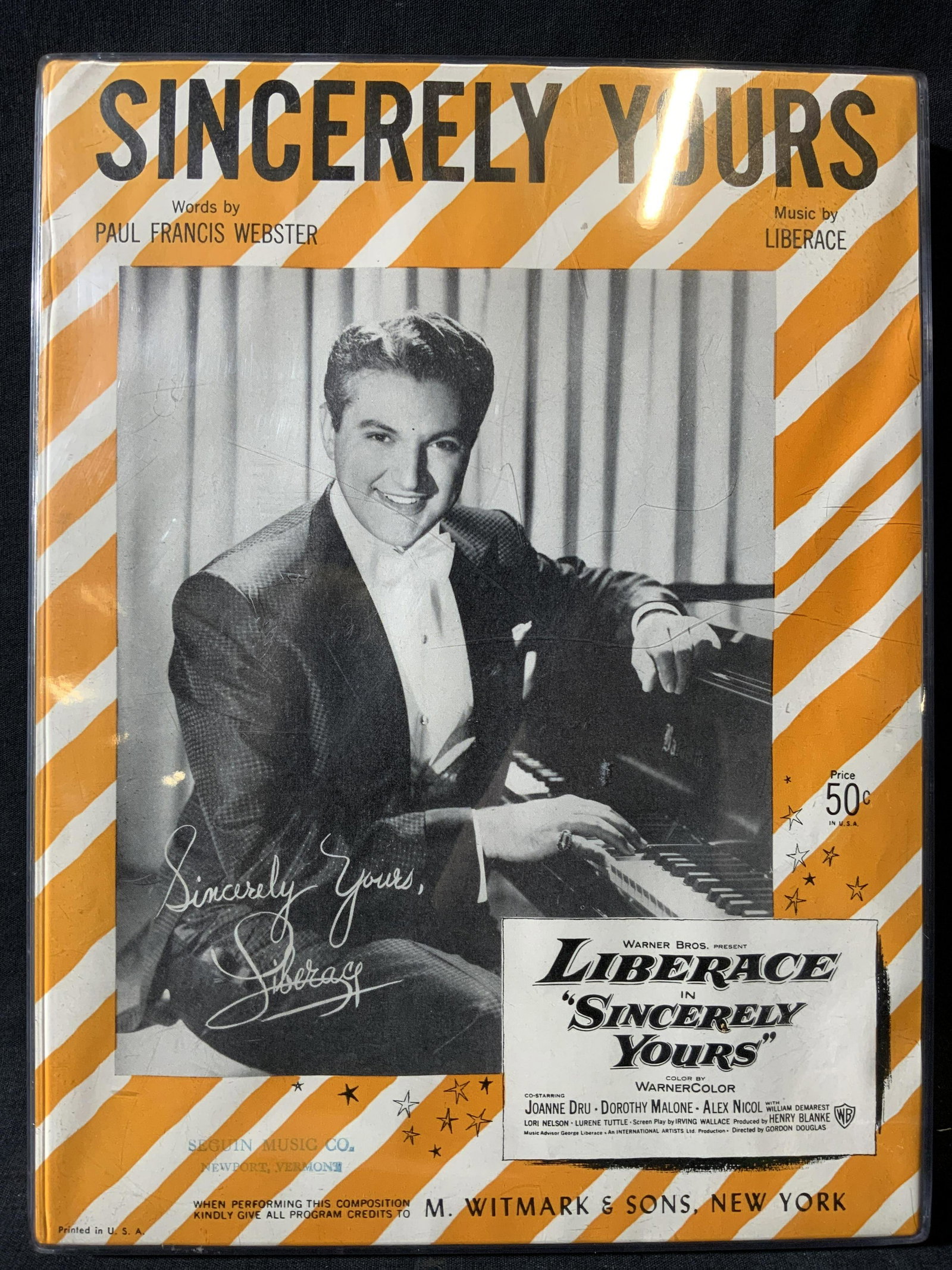 Liberace Sincerely Yours Advertisement: Liberace Sincerely Yours Advertisement, inscription in bottom reads ‘M. WITMARK & SONS’, subject a Sincerely Yours advertisement with printed signature, measures 9 1/4 x 12 1/4 inches, framed in a