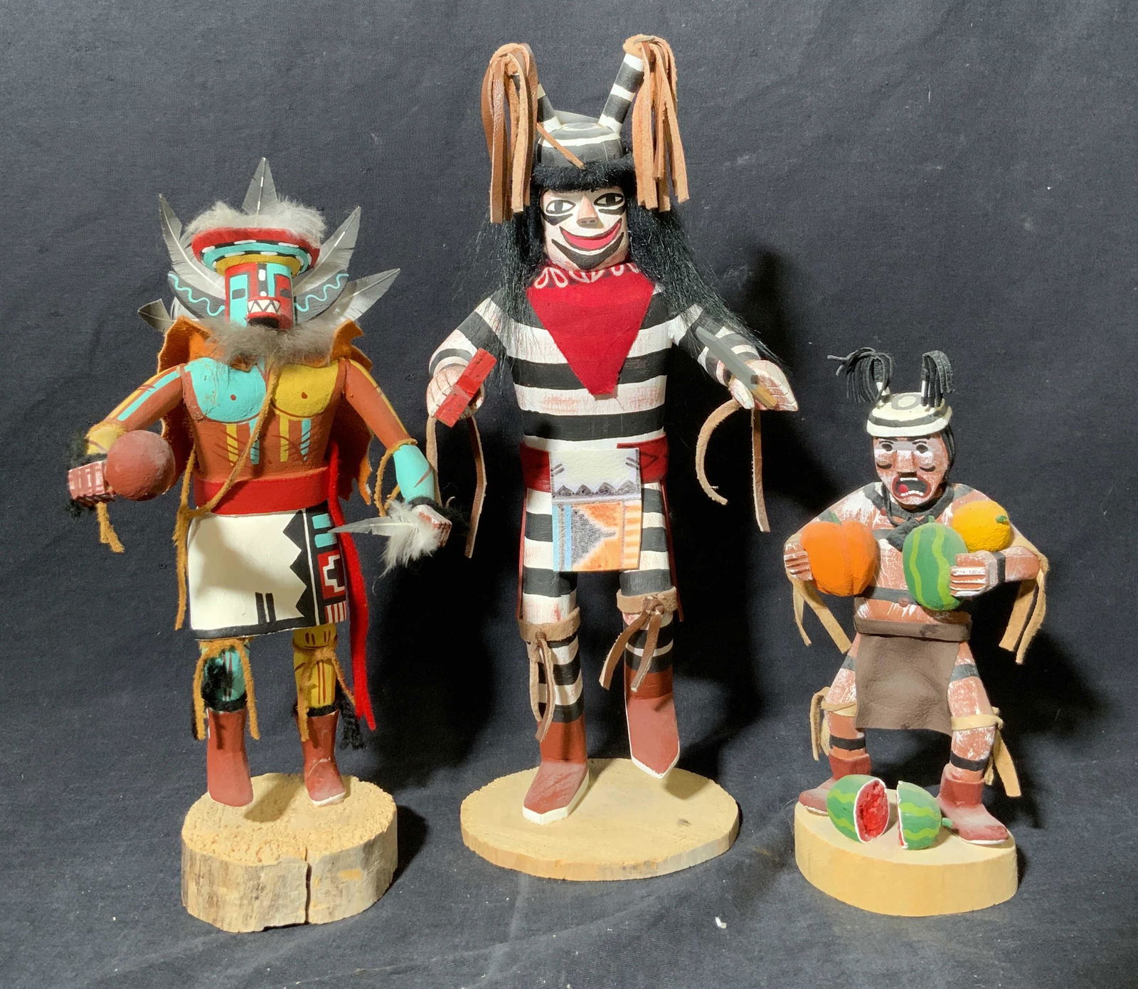 Hopi People Kachina Doll: Hopi People Kachina Doll, inscriptions to base read ‘whipper… hano clown… m wood’’, measure (from left to right) 2 3/4 x 8 1/2 inches, 3 7/8 x 10 1/2 inches, 2 3/8 x 7 1/2 inches, dolls I ar