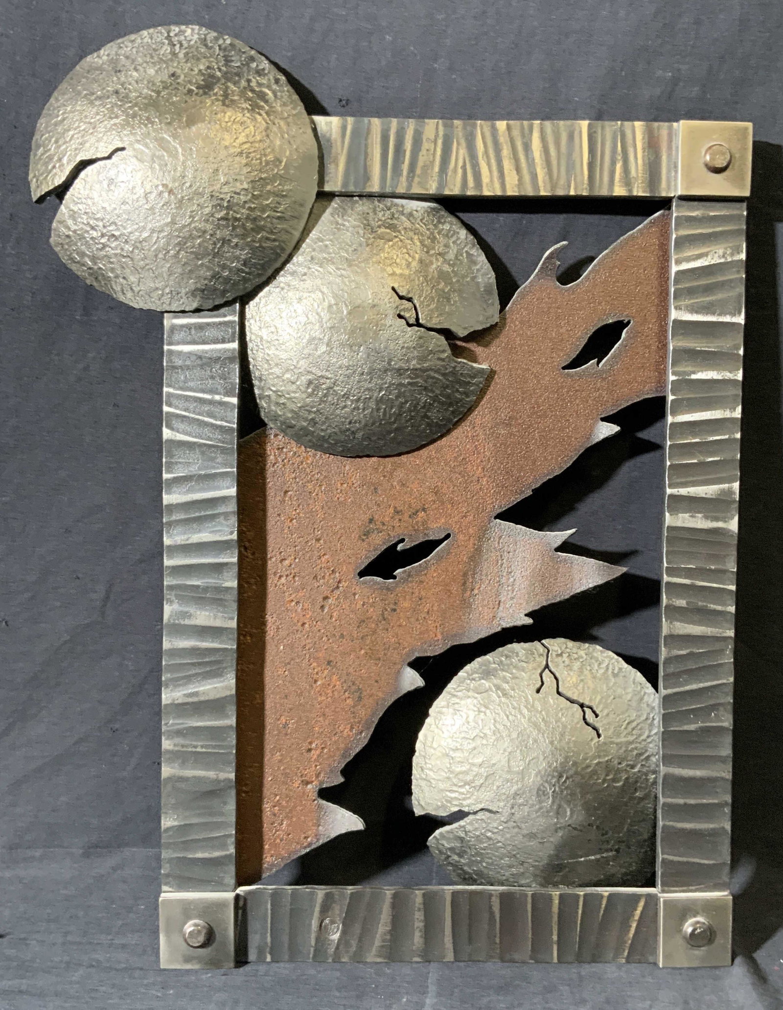 Ironwork Scene of Destruction: Ironwork Scene of Destruction, verso reads ‘2008’, subject three cracked orbs and flames, possibly iron or steel, measures 14 1/2 x 19, frame likely iron or steel, surface wear to piece. Artwork, 