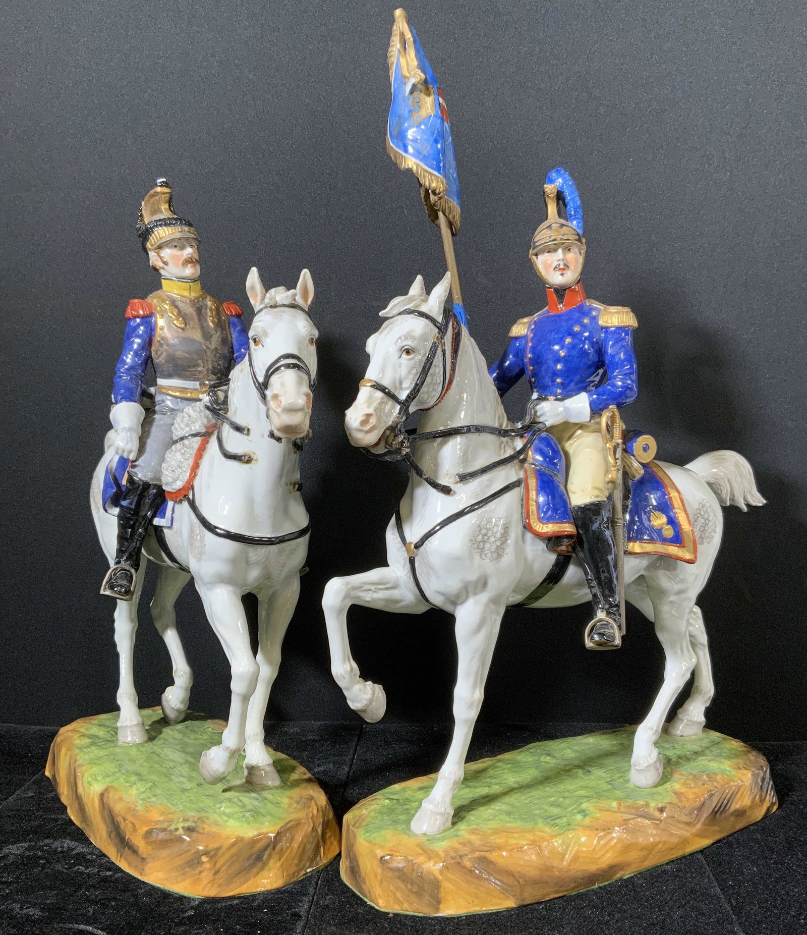 CAPODIMONTE Hand Painted Cavalrymen Figurals: Hand painted capodimonte cavalrymen Figurals. Underside marked with capodimonte trademark. Wear is consistent with age and use, Evident loss present on Figurals. Depicts two men on horseback, Measures