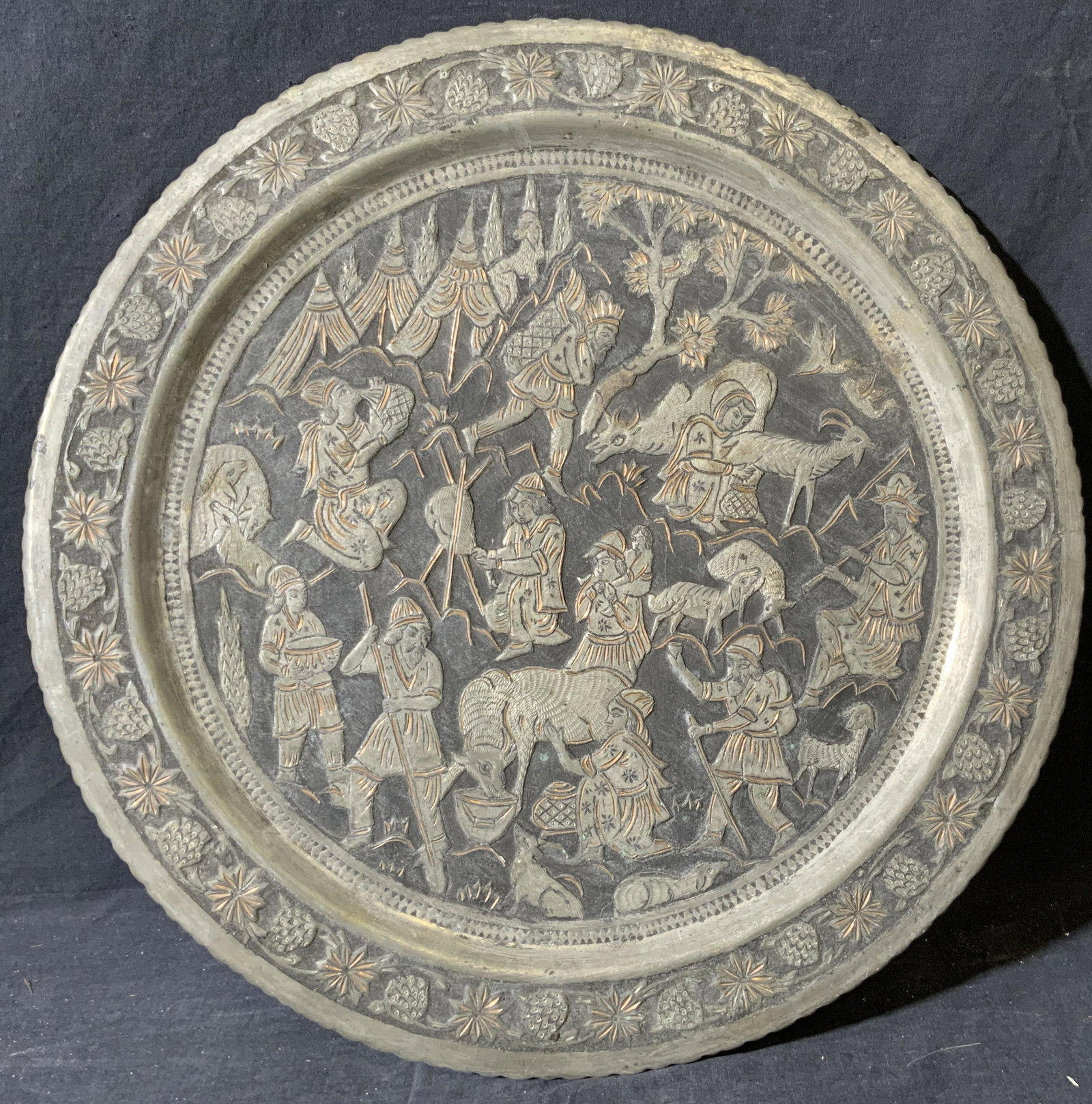 Village Scene On Metal Plate: Village Scene On Metal Plate, possibly bronze, no apparent inscriptions or marks to piece, subject many villagers doing daily chores, measures 19 1/2 x 19 1/2 inches, surface wear to piece. Artwork, f