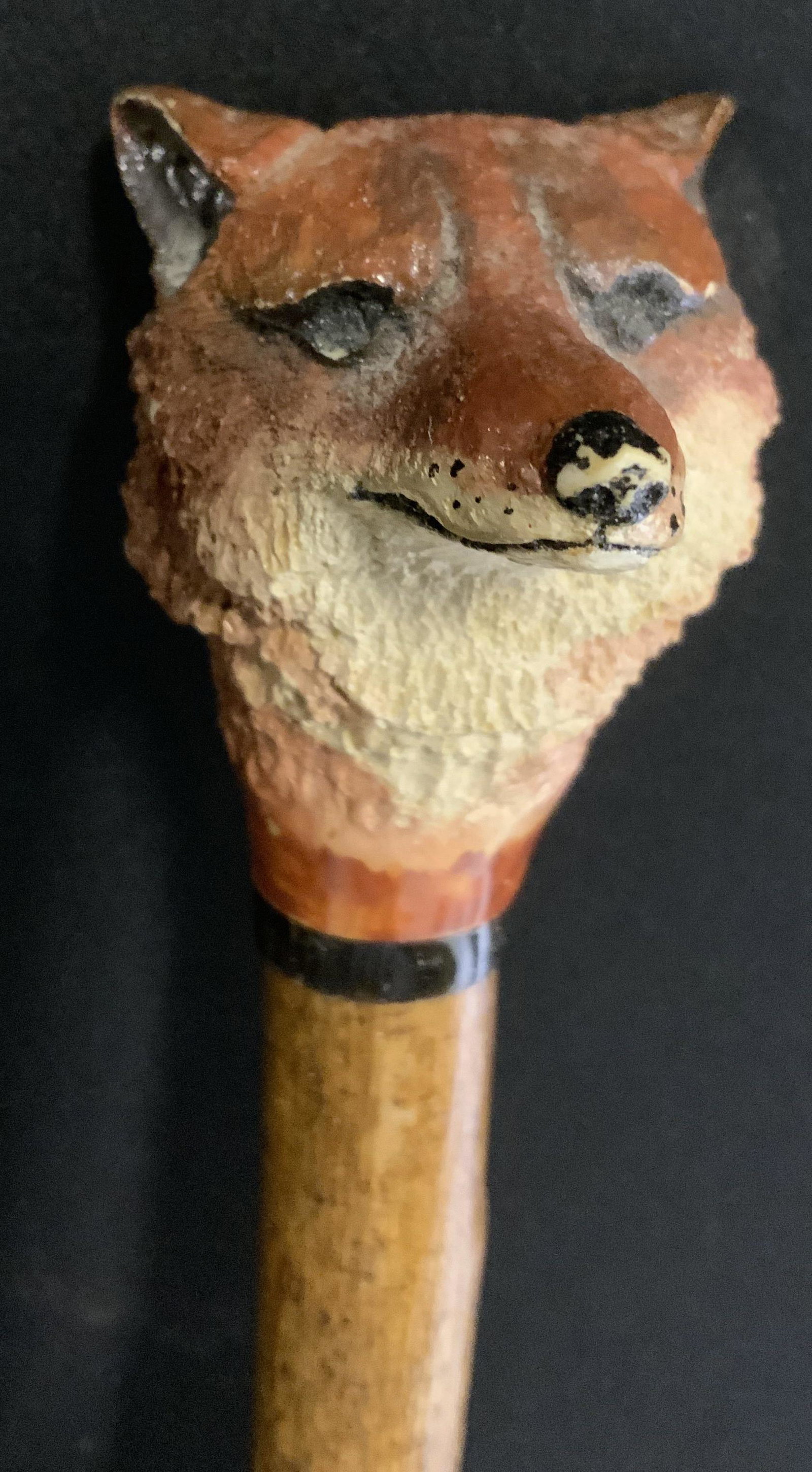 Vintage Fox Head Walking Stick: Vintage walking stick. Handle is scrimshaw, possibly on resin. Resembles a fox’s head. Shaft is wooden, walnut finish, metal ferrule. Wear is consistent with age and use, some chipping to wolf ears.