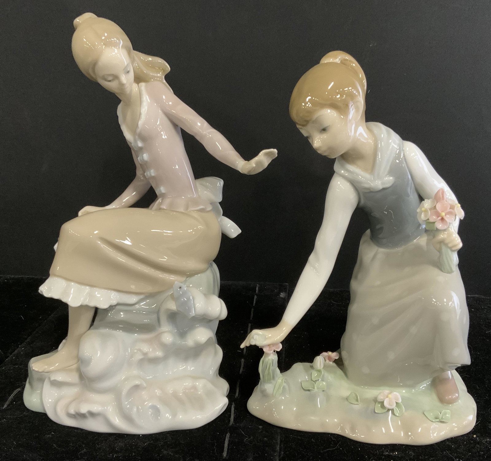 Lot 2 LLADRO Ceramic Figurals: Lot 2 lladro Figurals. Undersides stamped LLADRO MADE IN SPAIN. One depicts a girl among crashing waves, the other a girl picking flowers. Wear is consistent with age and use, chipping present. Larges