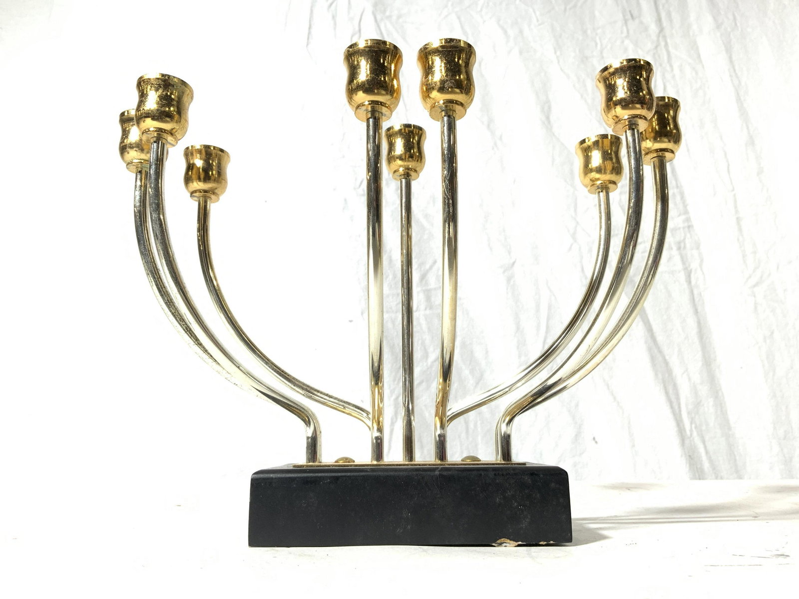 KARSHII Judaica Candelabra Menorah: Backside of piece has sticker which reads KARSHII. Piece is silver & gold toned. Base of piece appears to possibly be wooden. Piece measures approx 9.5 inches long 8 inches tall 5.5 inches deep. Menor