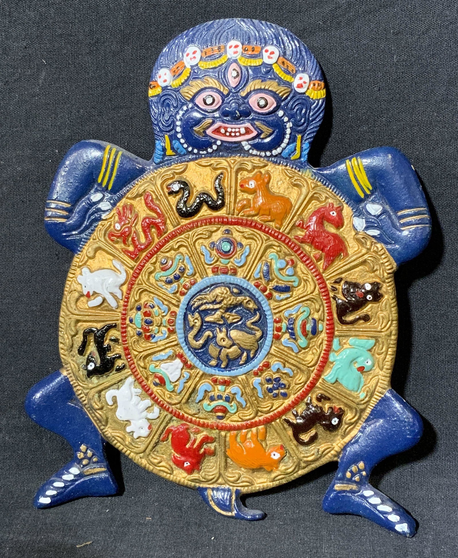 Vintage Chinese Zodiac Cast Metal Wall Plaque: Vintage Chinese Zodiac Cast Metal Wall Plaque, Depicts some mythological creature holding the Chinese Zodiac Calender. It is fairly heavy for the size and very detailed. It measures 5.75" long and 7.5