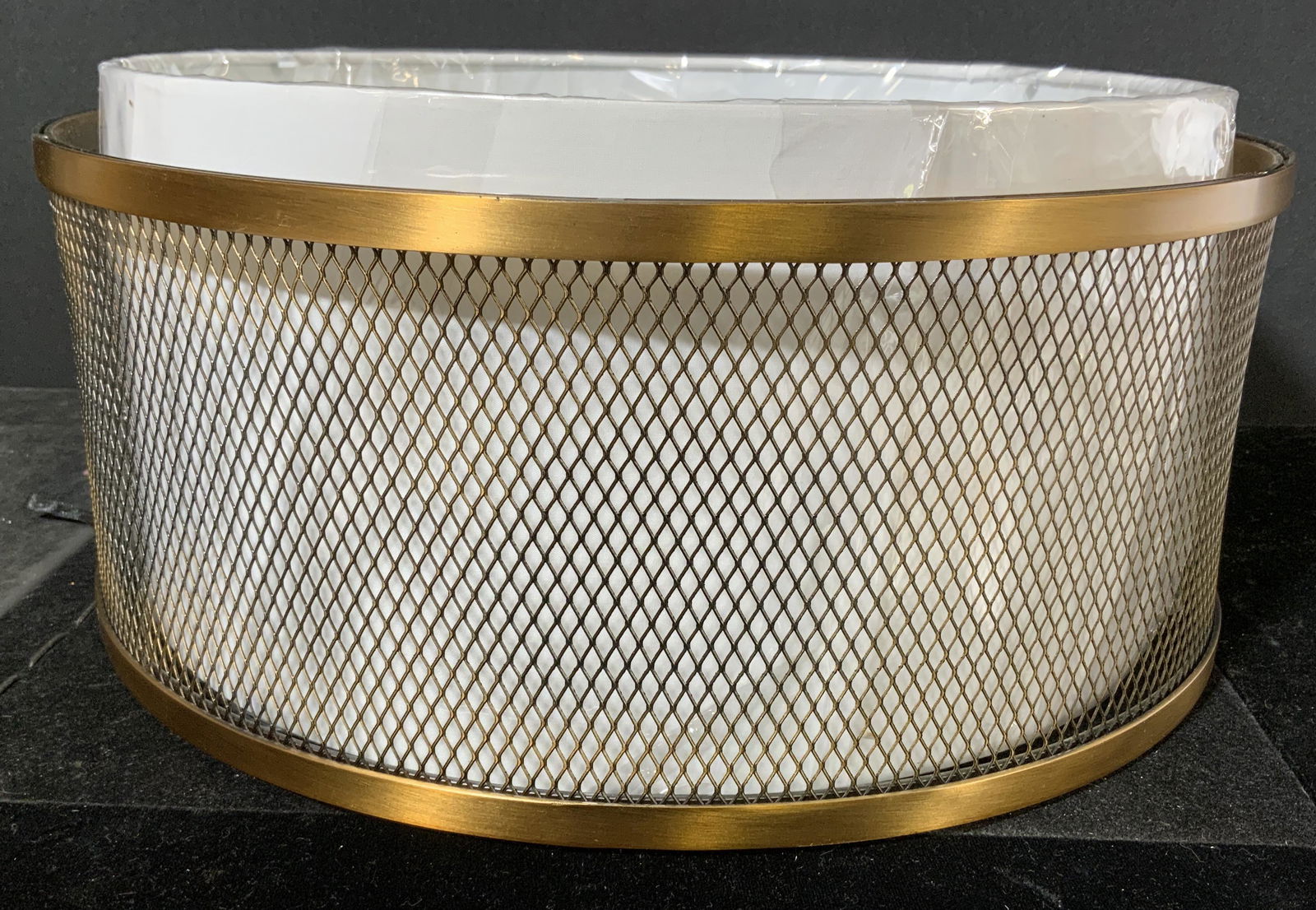 Metal Mesh Drum Chandelier: Drum chandelier, shade housed within a brass toned metal mesh cage. Wear is consistent with use, functionality has not been tested. Measures approx 6.5 inches h and 15 inches in diameter. Chandelier,