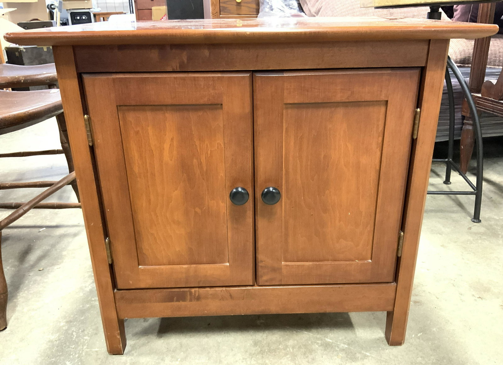 NADEAU Wooden Side Table W Cabinet: Backside of side table is stamped NADEAU MADE IN CANADA. Piece has cabinet door storage space with a shelf inside. Piece measures approx 22.5 inches tall 26 inches wide 19 inches deep. Side table, end