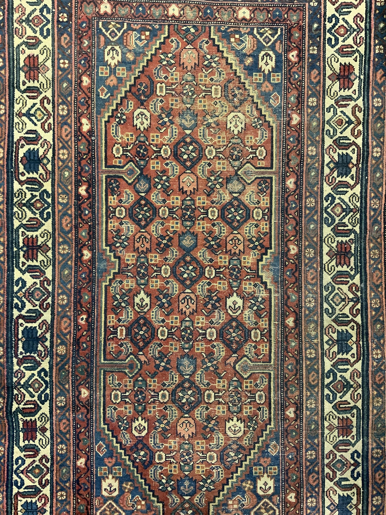 Vintage Handmade Wool Area Rug: Rug is handmade and wool. Piece is vintage possibly antique. Rug has intricate multi toned floral, leaf & geometric detail. Piece measures approx 80 inches long 51 inches wide. Rug, carpet, wool rug, 