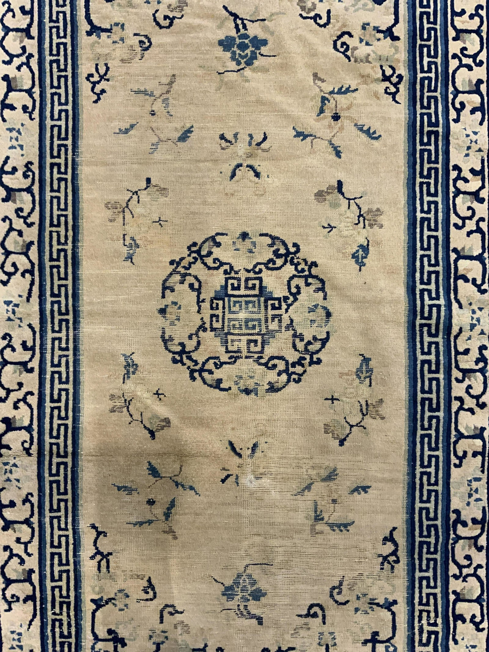 Vintage Handmade Chinese Art Deco Wool Rug: Rug is handmade and wool. Piece is vintage possibly antique. Rug is Chinese Art Deco. Piece has blue, tan & slate toned floral, vine, leaf & geometric detail. Piece measures approx 78 inches long 47 i